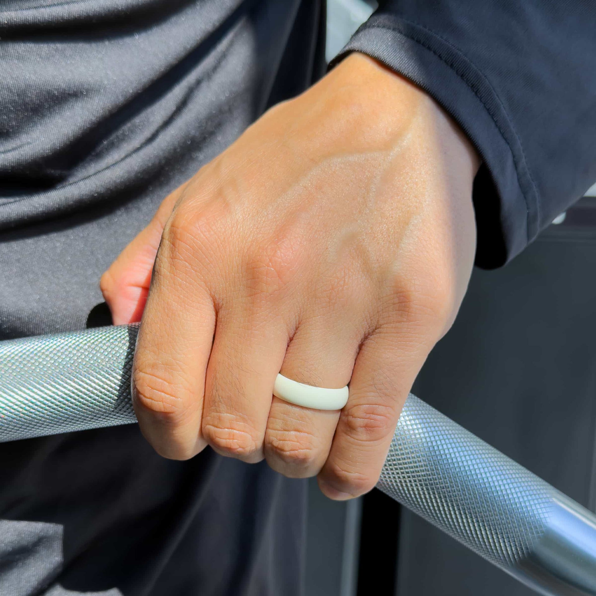 neutral tan silicone alternative band worn by male model in a gym setting