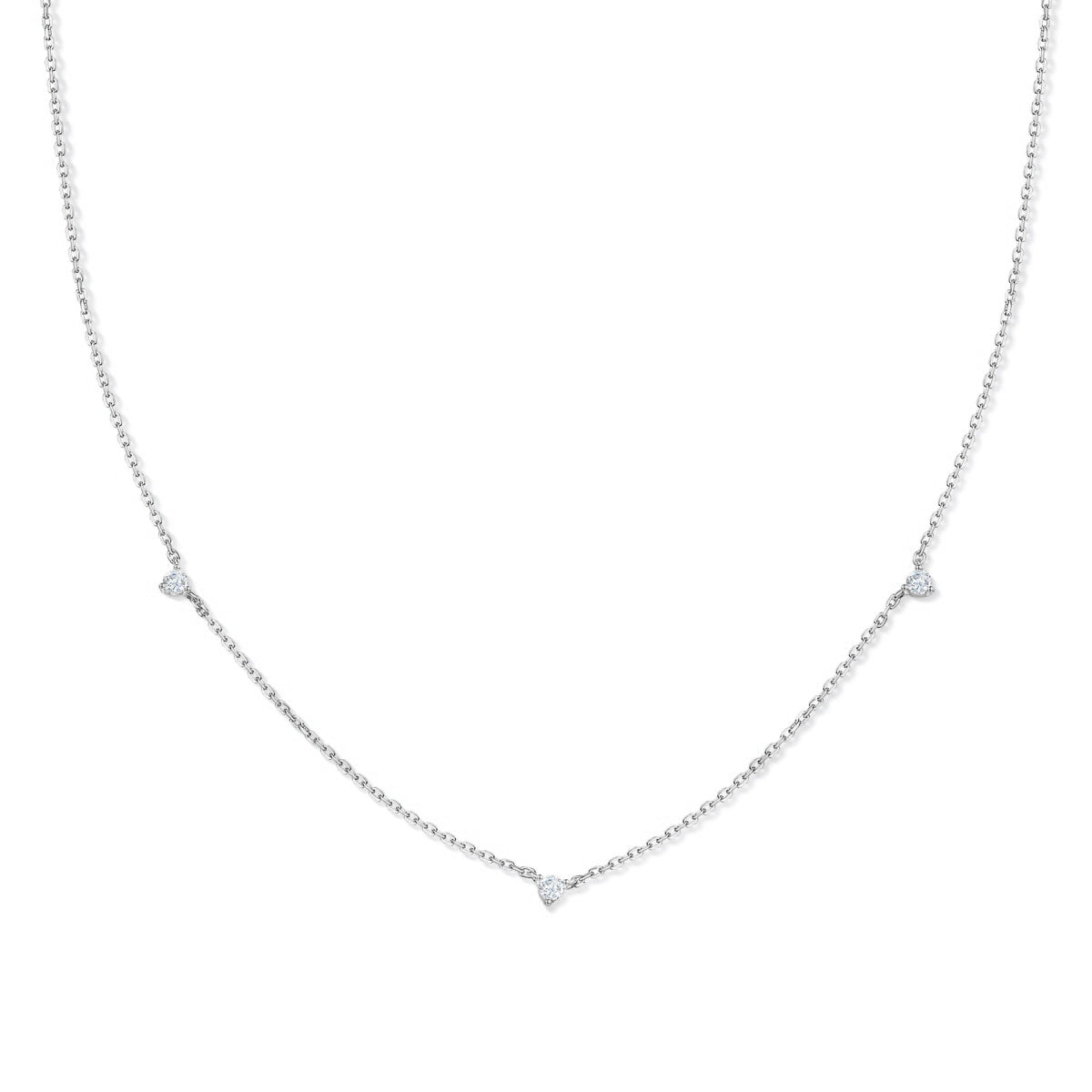 simple silver necklace with 3 dainty round stones along its chain on a white background