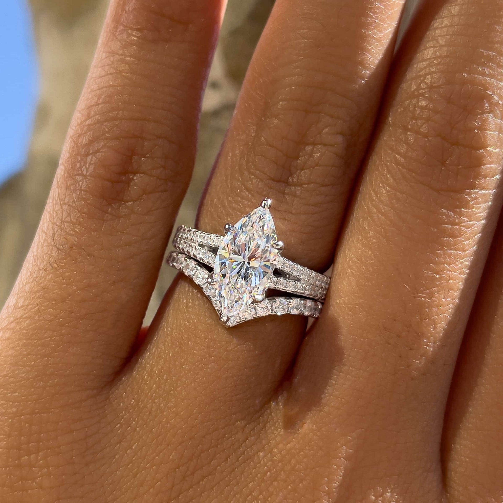 Silver wedding set made of 2 carat marquise cut split shank engagement ring and half eternity chevron band on model