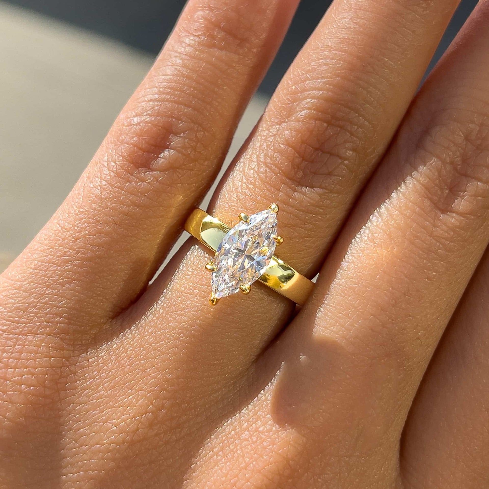 stunning 2 carat marquise cut solitaire ring with a thicker 3mm band on model