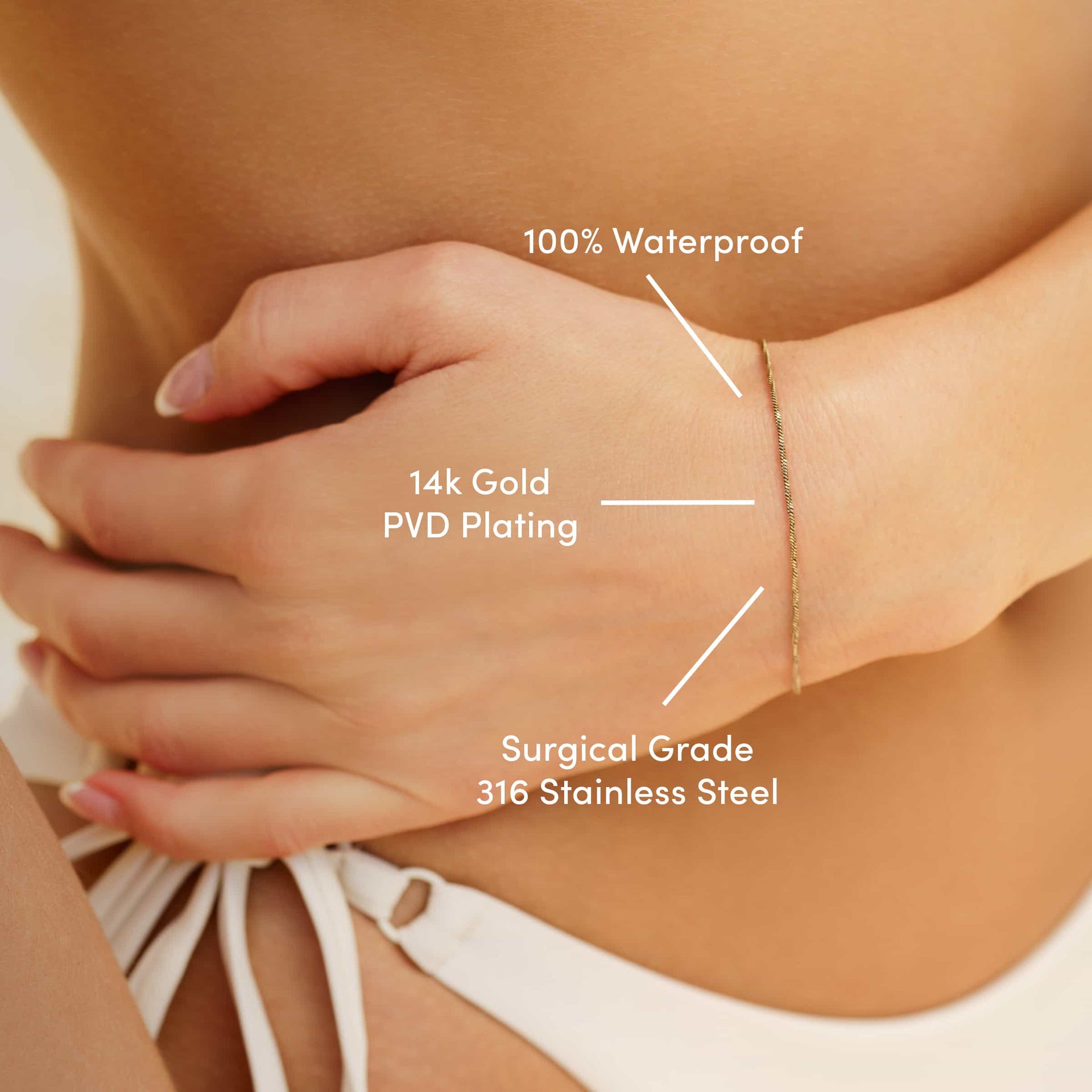a 14k gold PVD plated stainless steel snake chain bracelet worn by a model in a bikini with the text overlayed "100% waterproof, 14k gold PVD plating, & surgical grade 316 stainless steel"