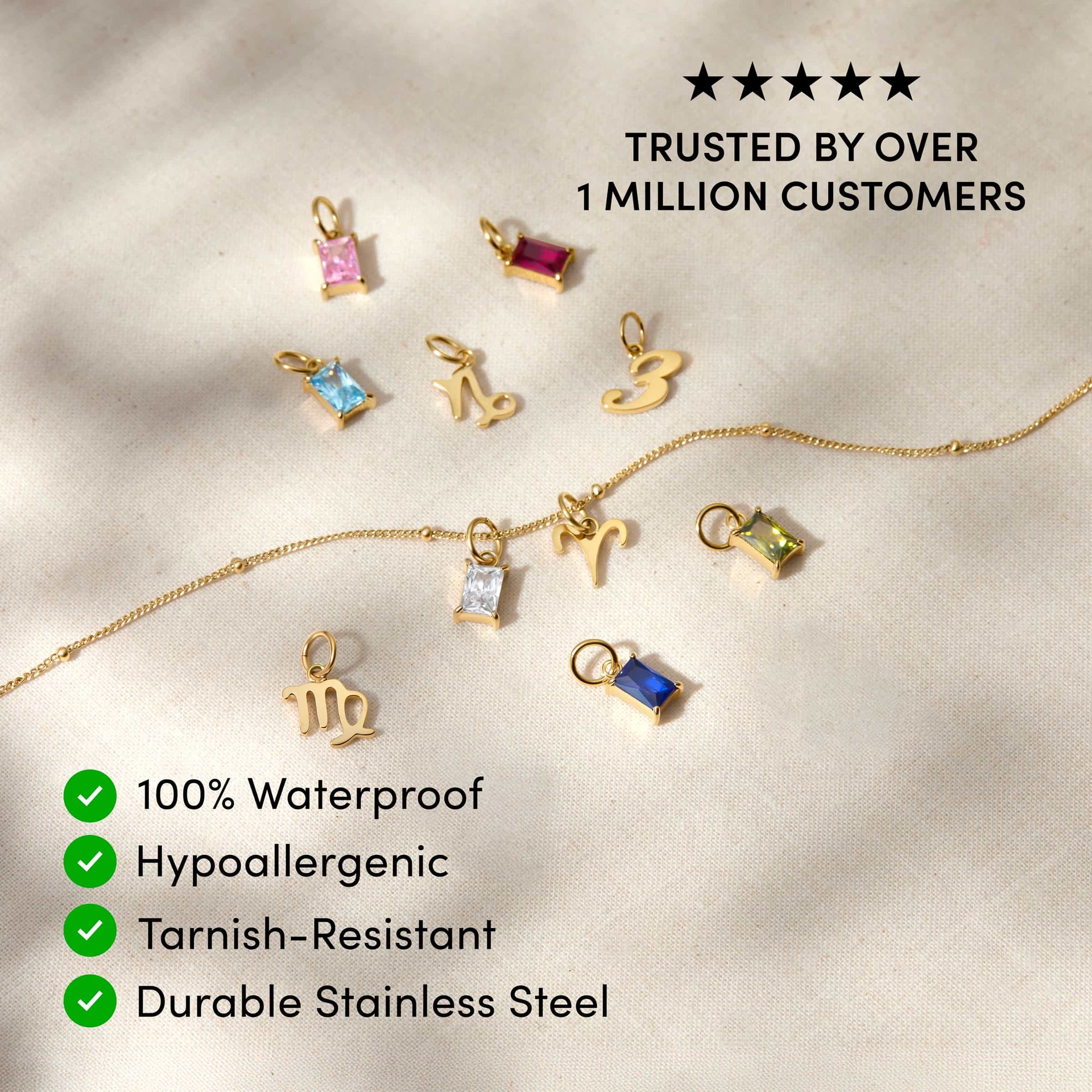 a variety of dainty charms posed across a tan surface with the text overlayed "trusted by over 1 million customers, 100% waterproof, hypoallergenic, tarnish-resistant, durable stainless steel"