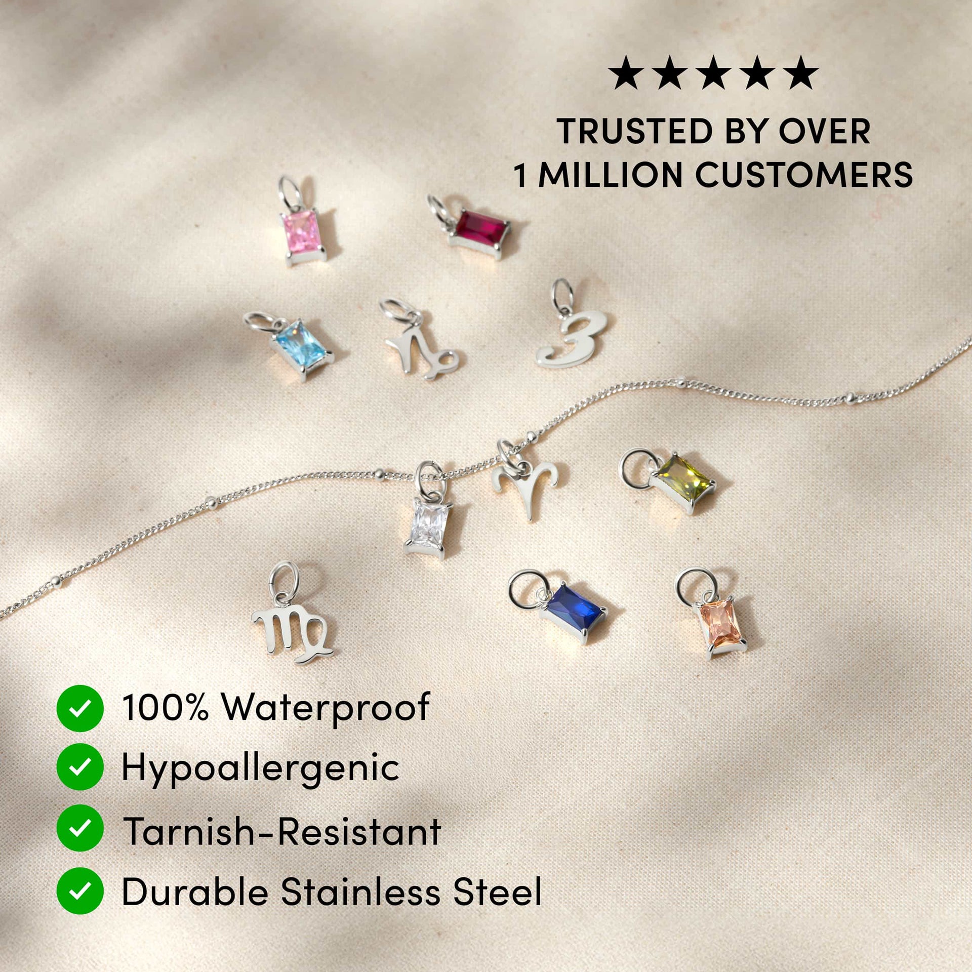 a variety of dainty charms posed across a tan surface with the text overlayed "trusted by over 1 million customers, 100% waterproof, hypoallergenic, tarnish-resistant, durable stainless steel"