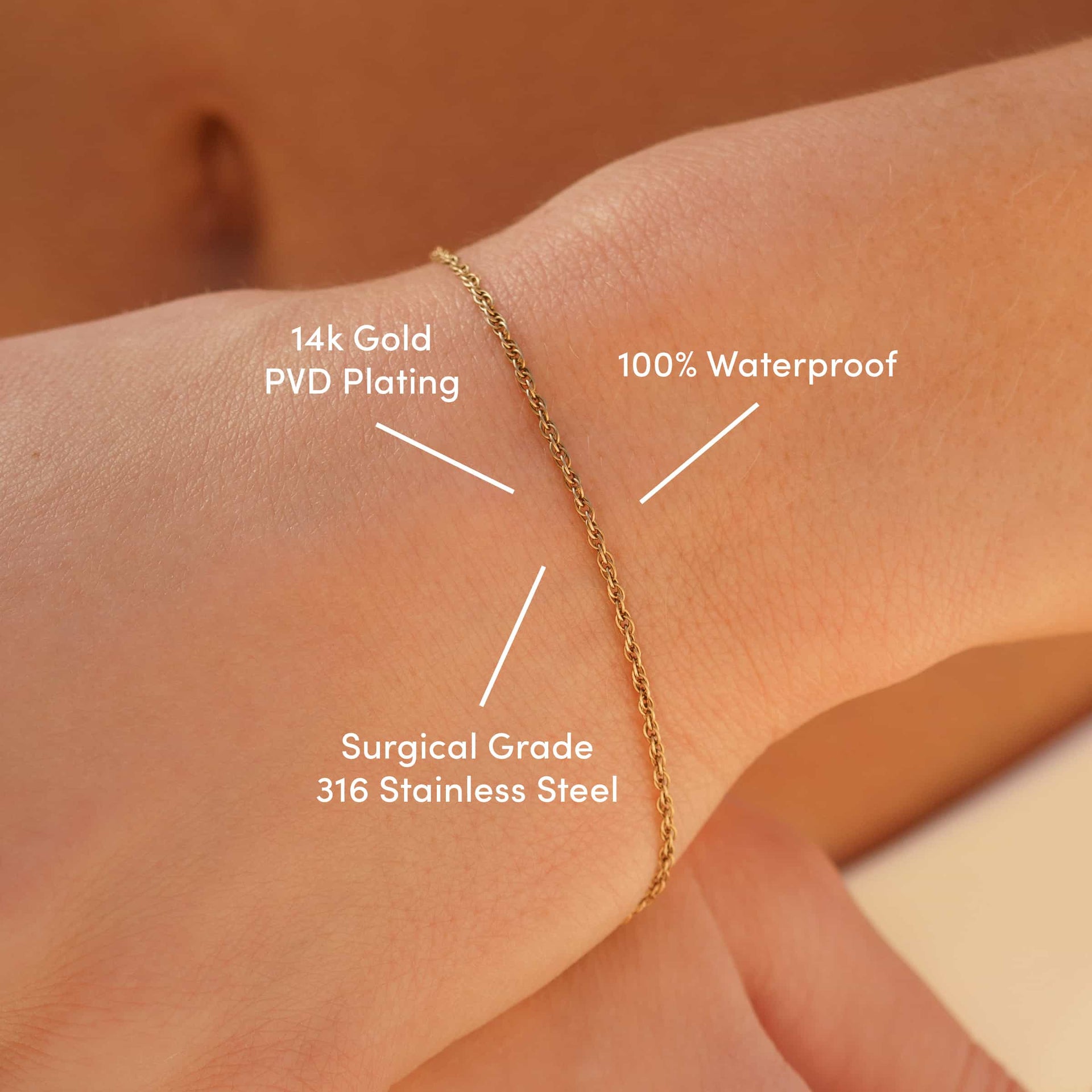 a 14k gold PVD plated stainless steel twisted detail cable chain bracelet worn by model with text overlayed "14k gold PVD Plating, 100% waterproof, surgical grade 316 stainless steel"