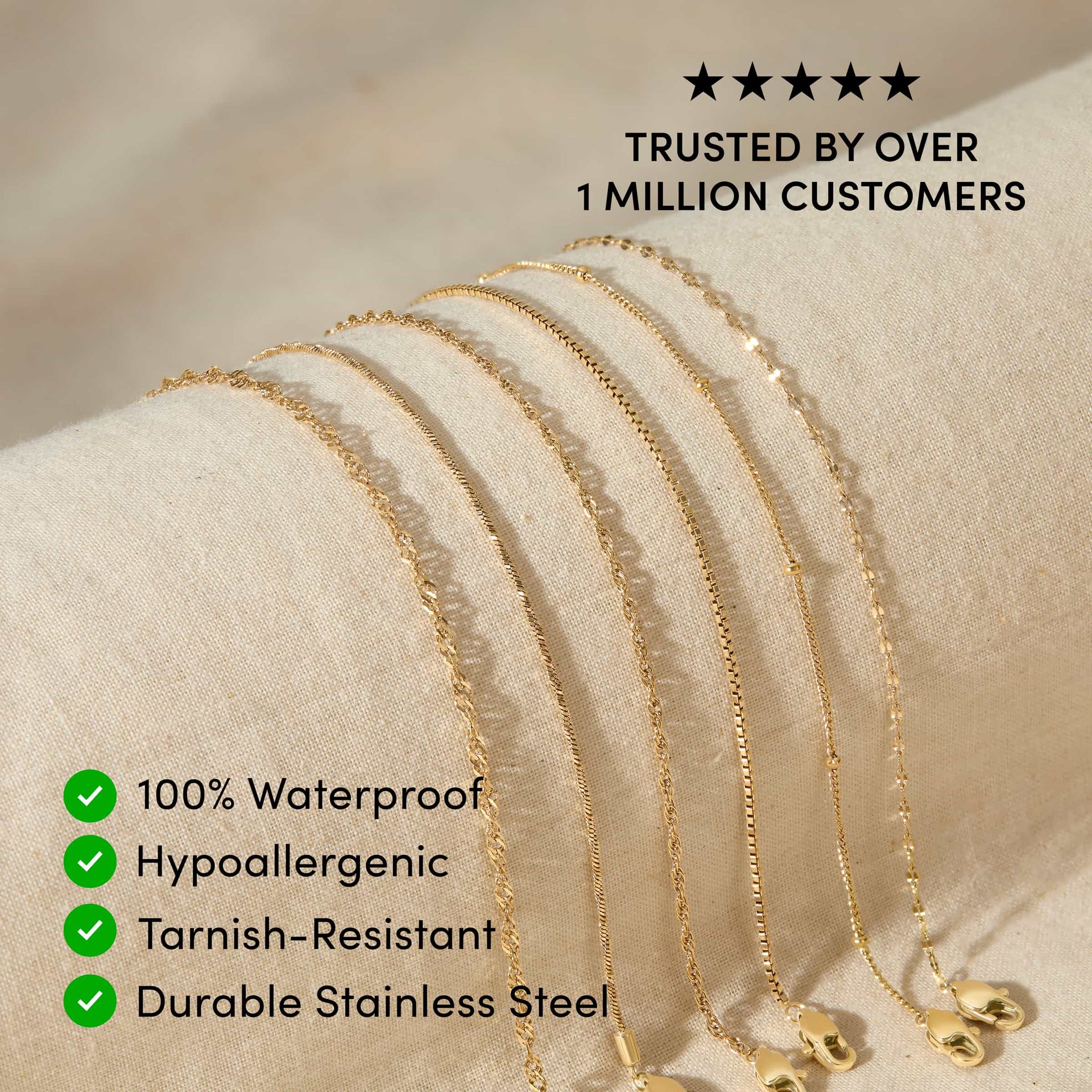 five 14k gold PVD plated stainless steel dainty chain bracelets resting across a tan surface with the text overlayed "trusted by over 1 million customers, 100% waterproof, hypoallergenic, tarnish-resistant, durable stainless steel"