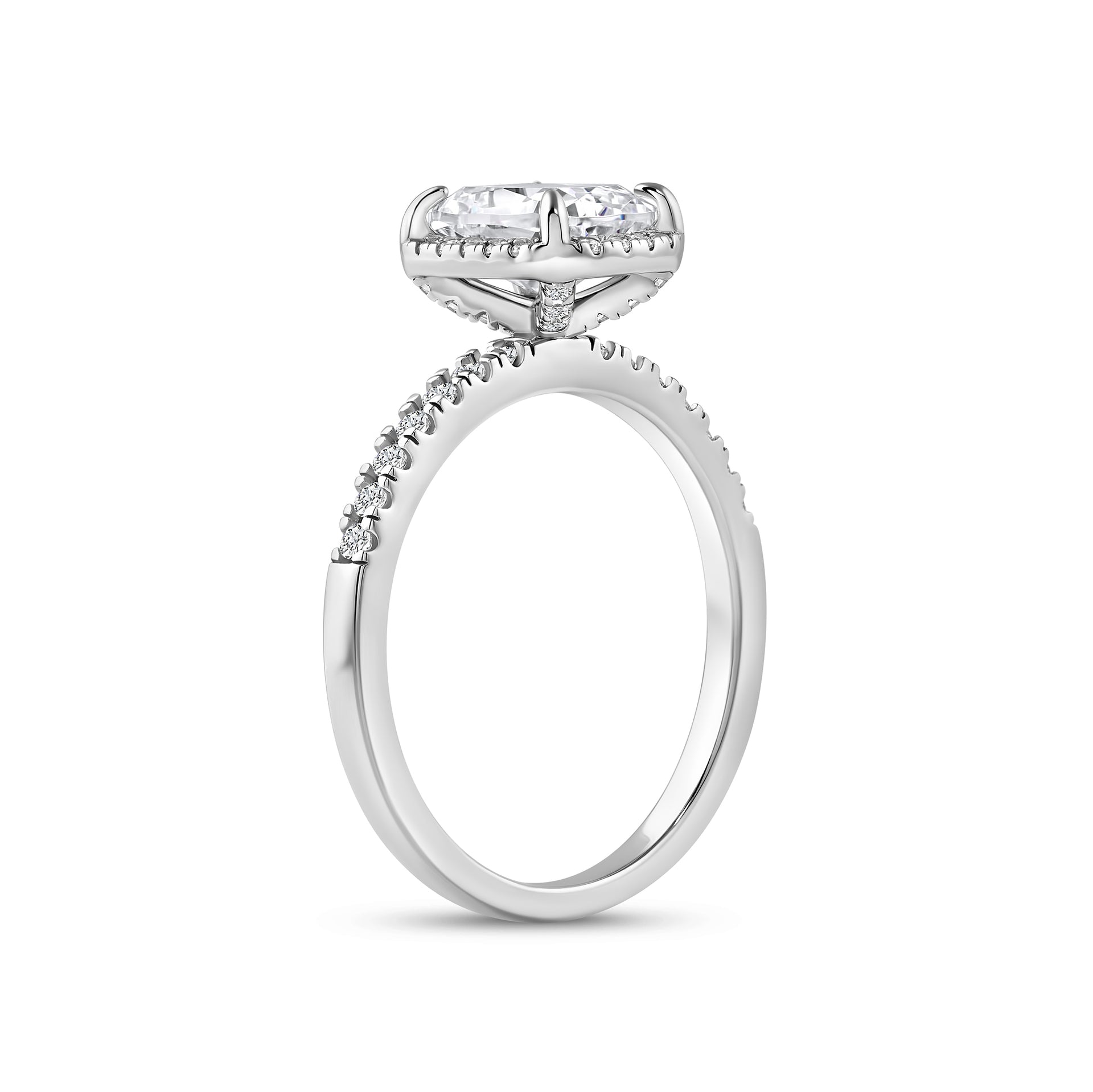 angled side view of silver 3 carat elongated cushion cut halo engagement ring on white background