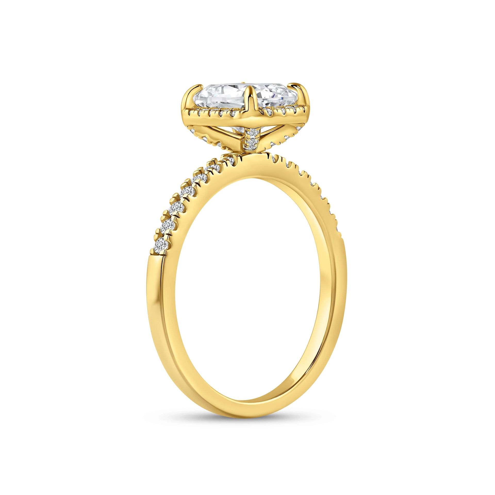 angled side view of gold 3 carat elongated cushion cut halo engagement ring on white background