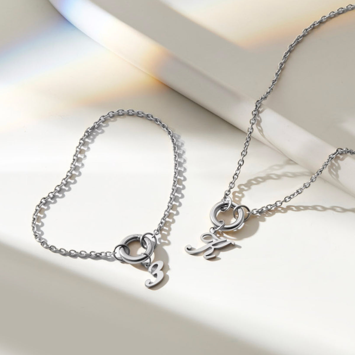 stainless steel cable chain charm bracelet  with a "3" charm & a charm necklace with a "K"