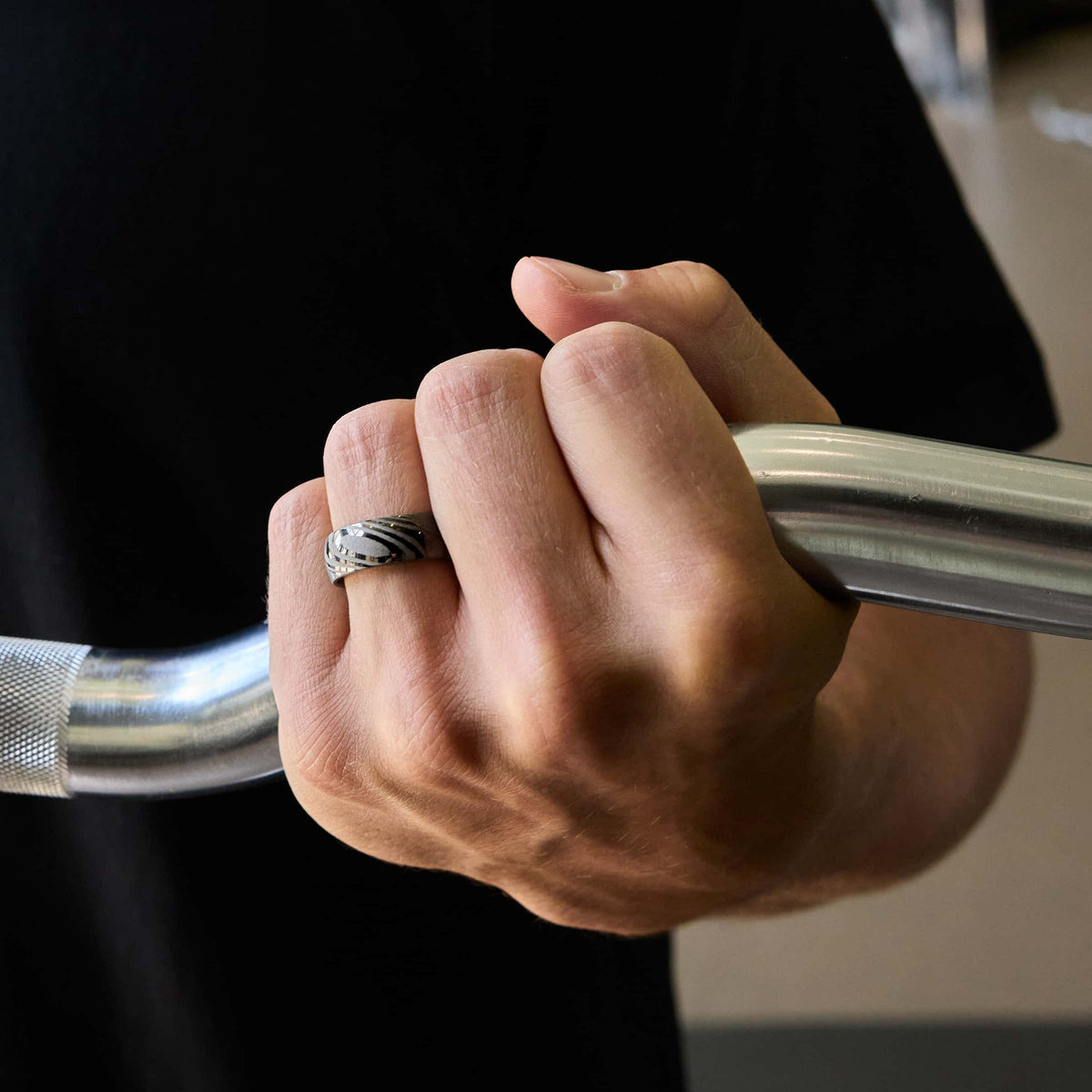 8mm damascus steel band on model at the gym