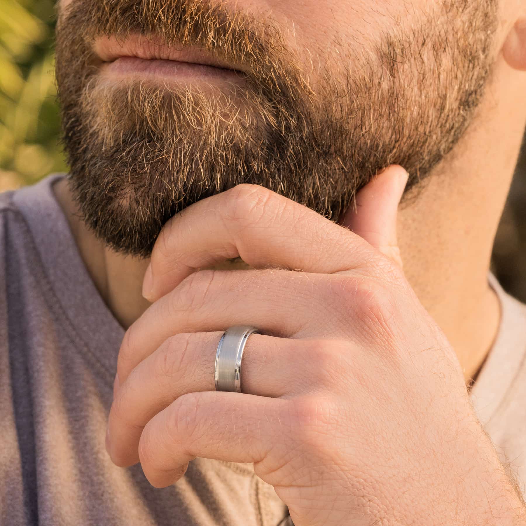 silver excalibur wedding band on man's hand