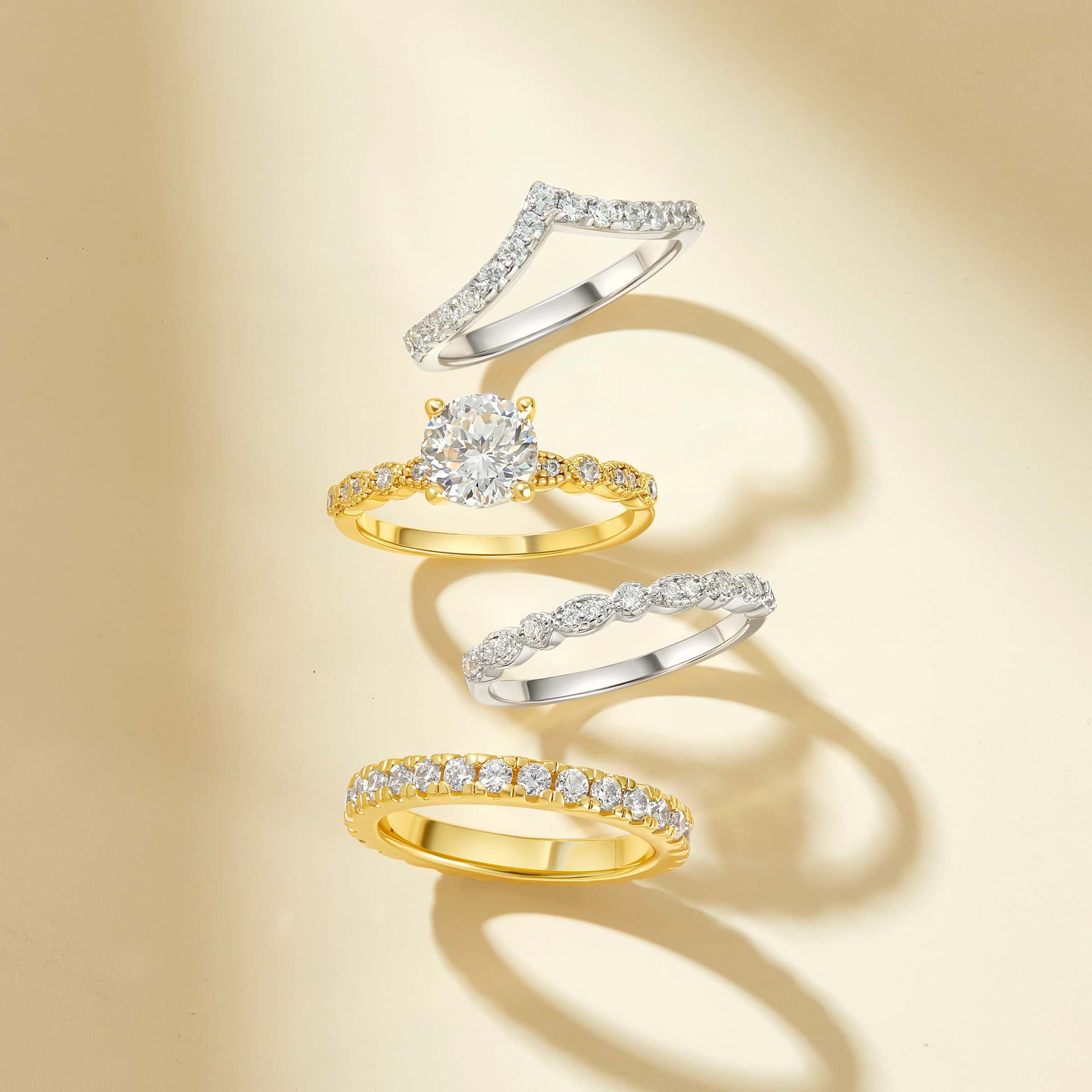 Stunning gold and silver wedding rings on a cream colored background