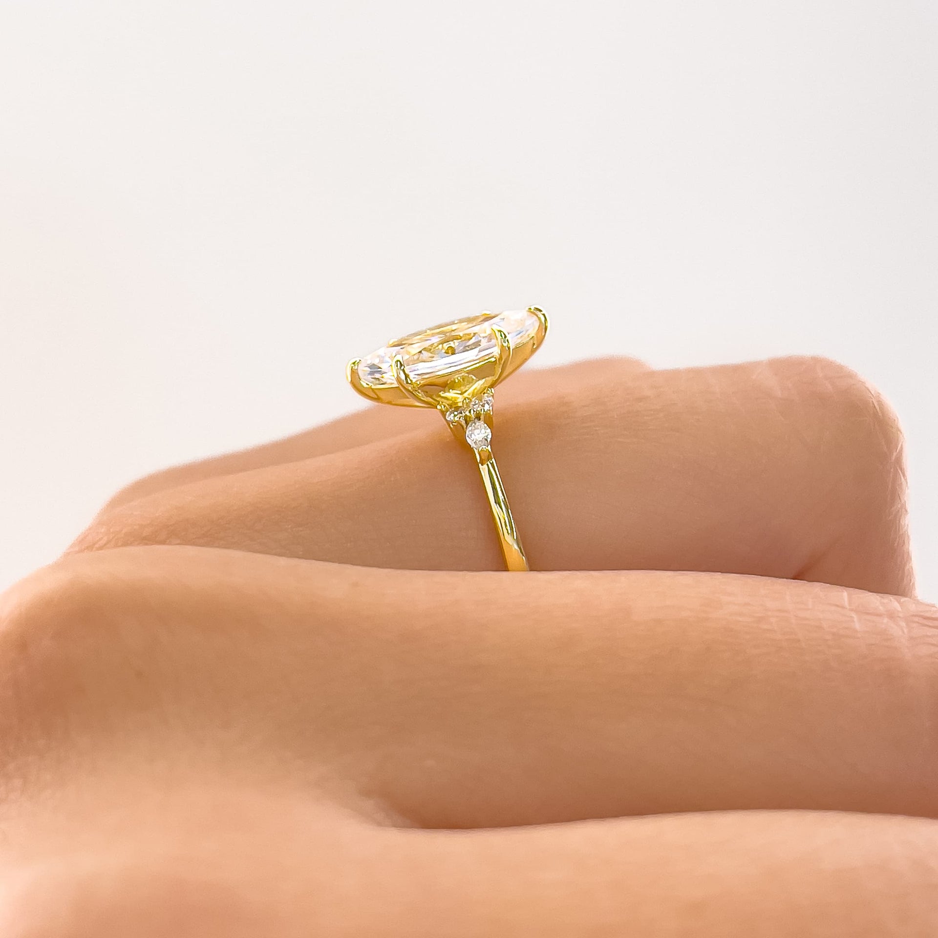 stunning gold marquise setting shot shown on ladies hand