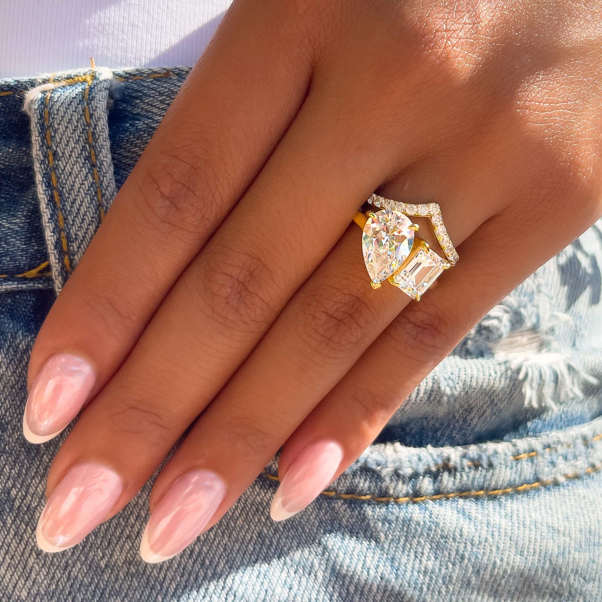 gold toi et moi style engagement ring paired with gold chevron half eternity wedding band