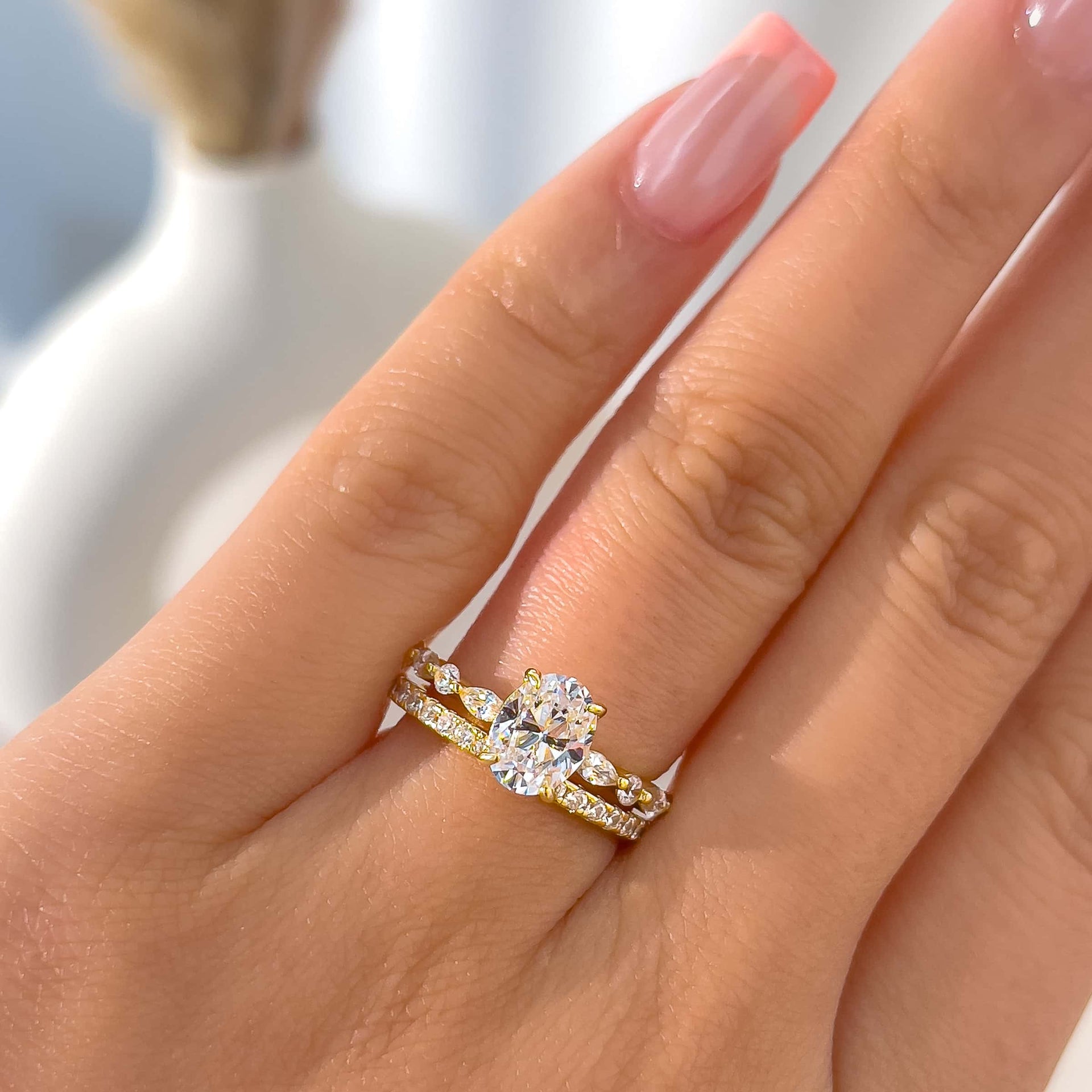 woman wearing gorgeous ring stack shown in silver with unique engagement ring and eternity style gold wedding band