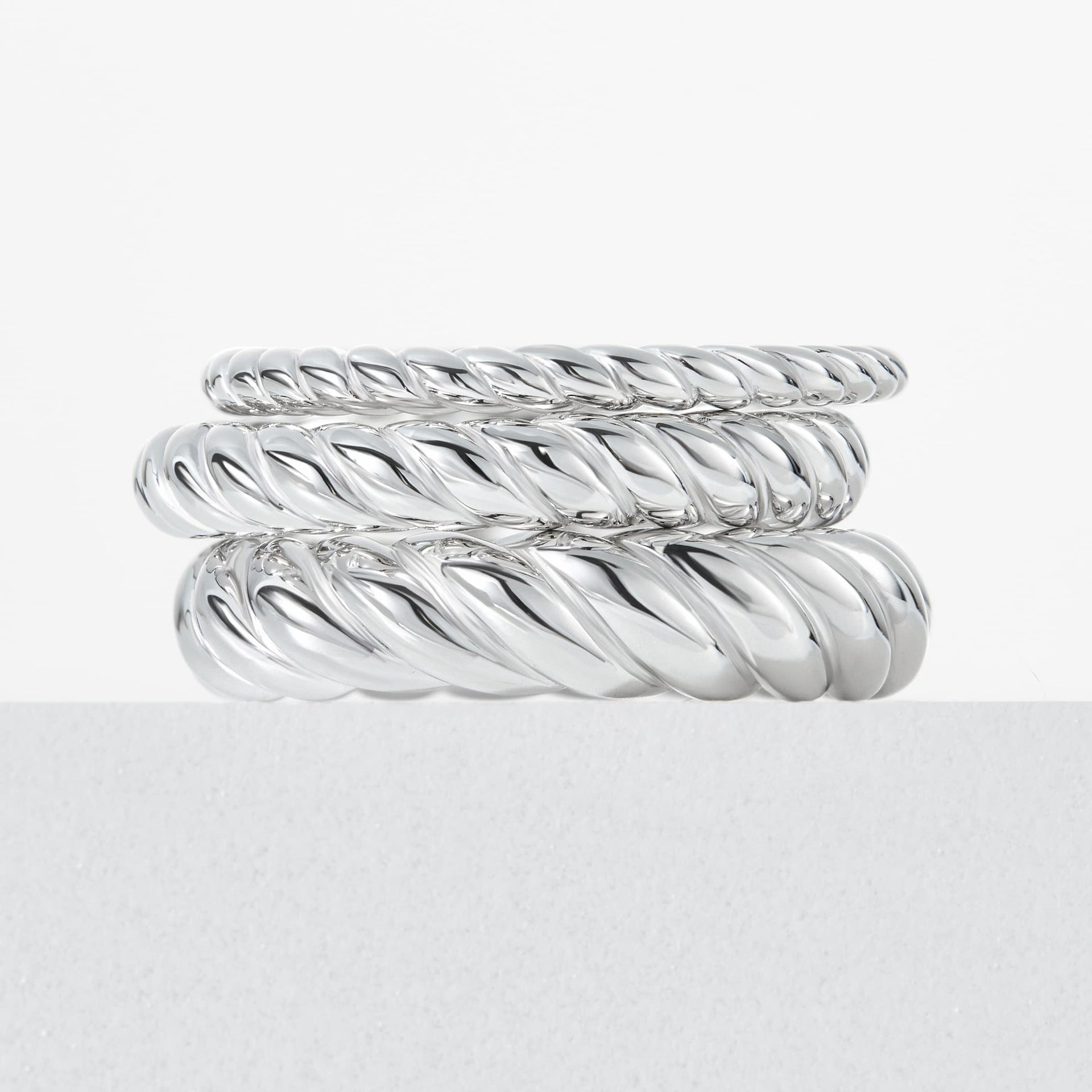 sleek silver 3-piece ring set that highlights the different widths of each ring