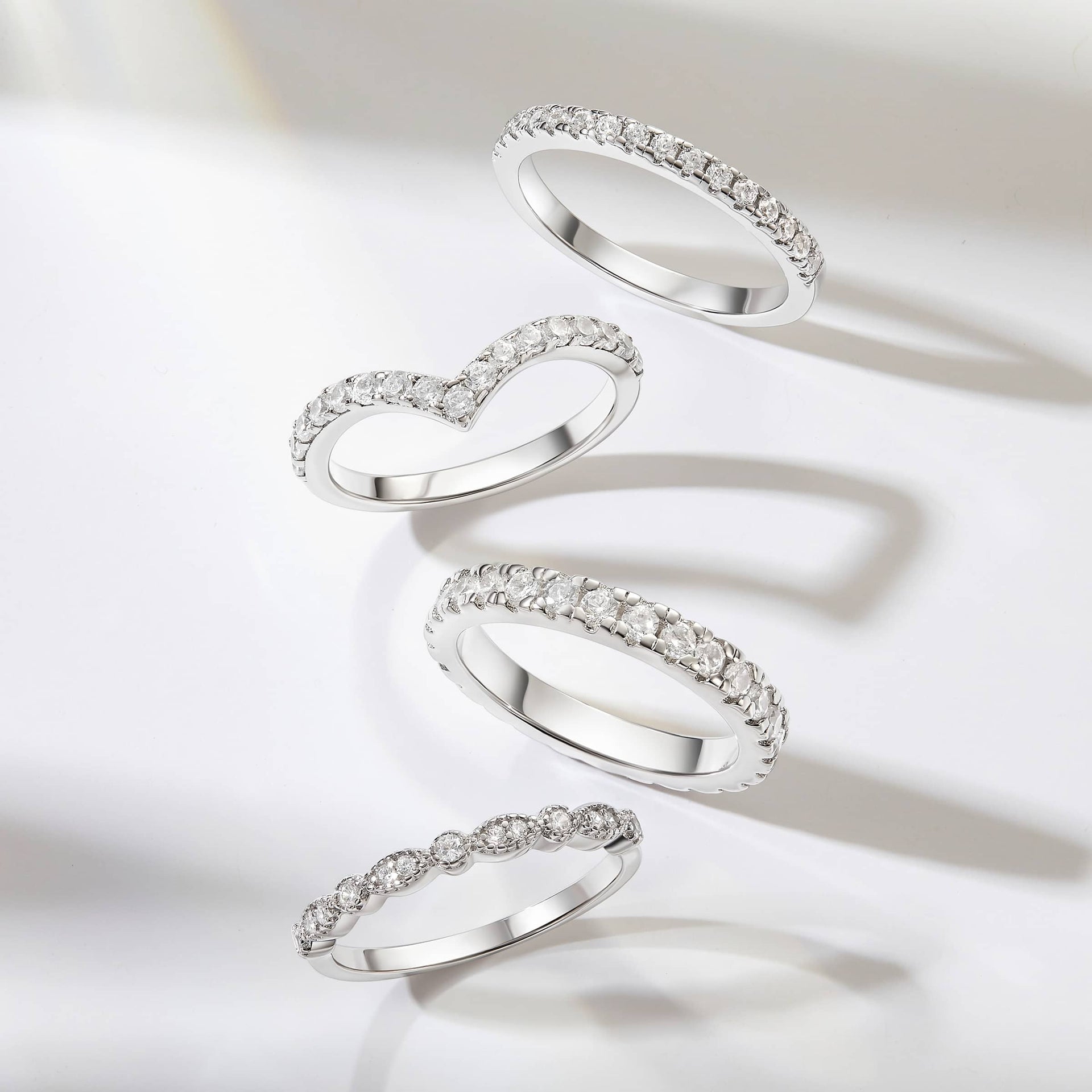 Sleek silver wedding bands on a grayish white background