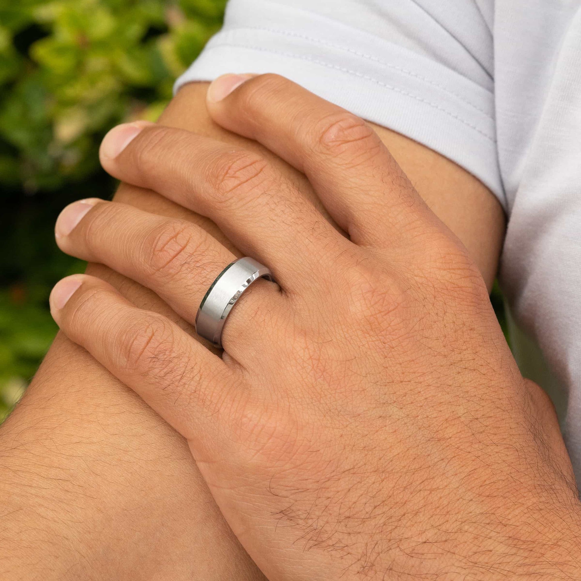 man wearing titan silver wedding band on hand