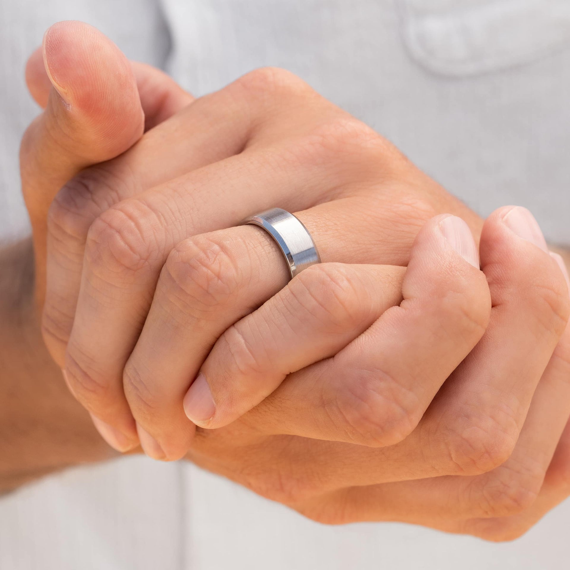 man wearing silver titan wedding band