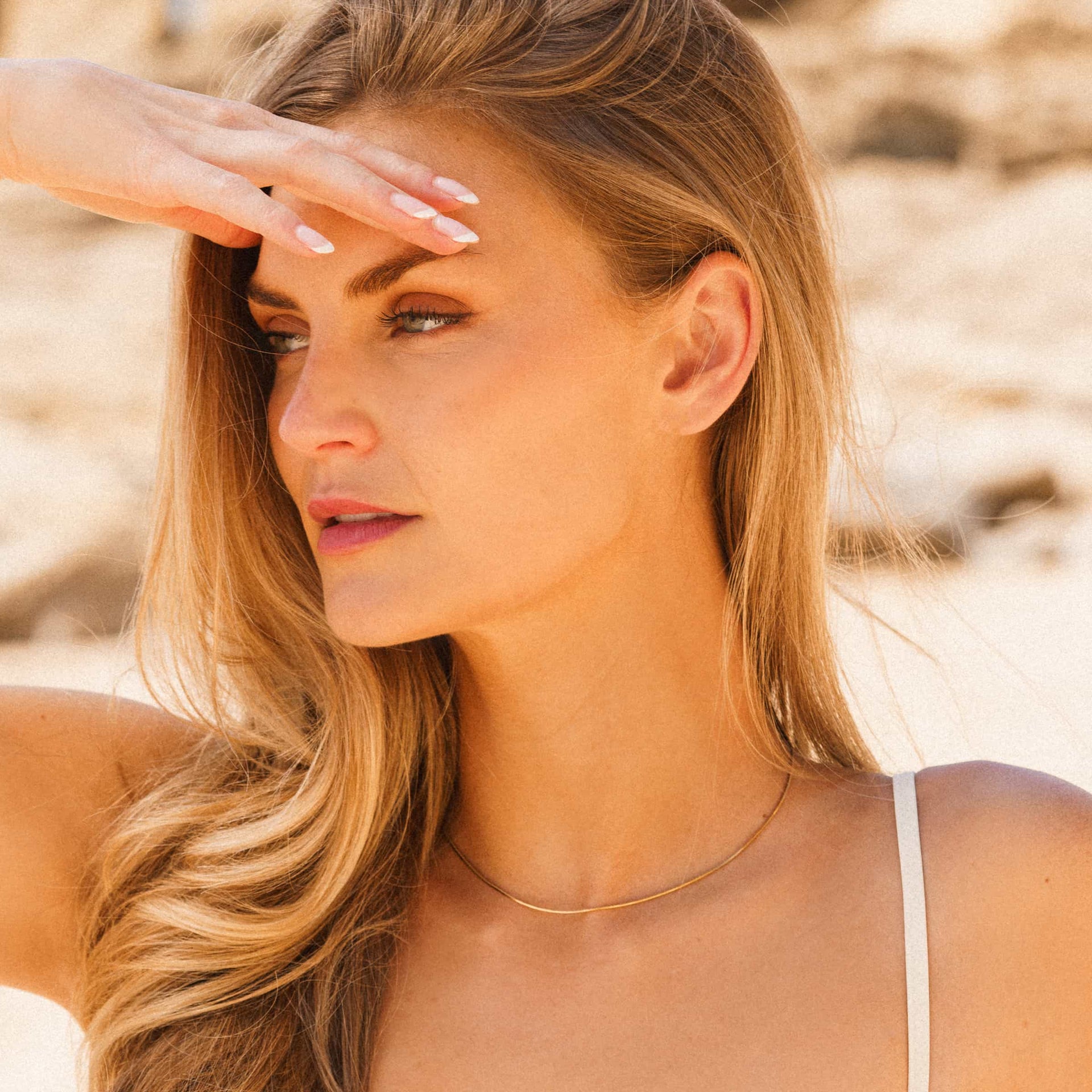 gold stainless steel snake chain on blonde model's neck 