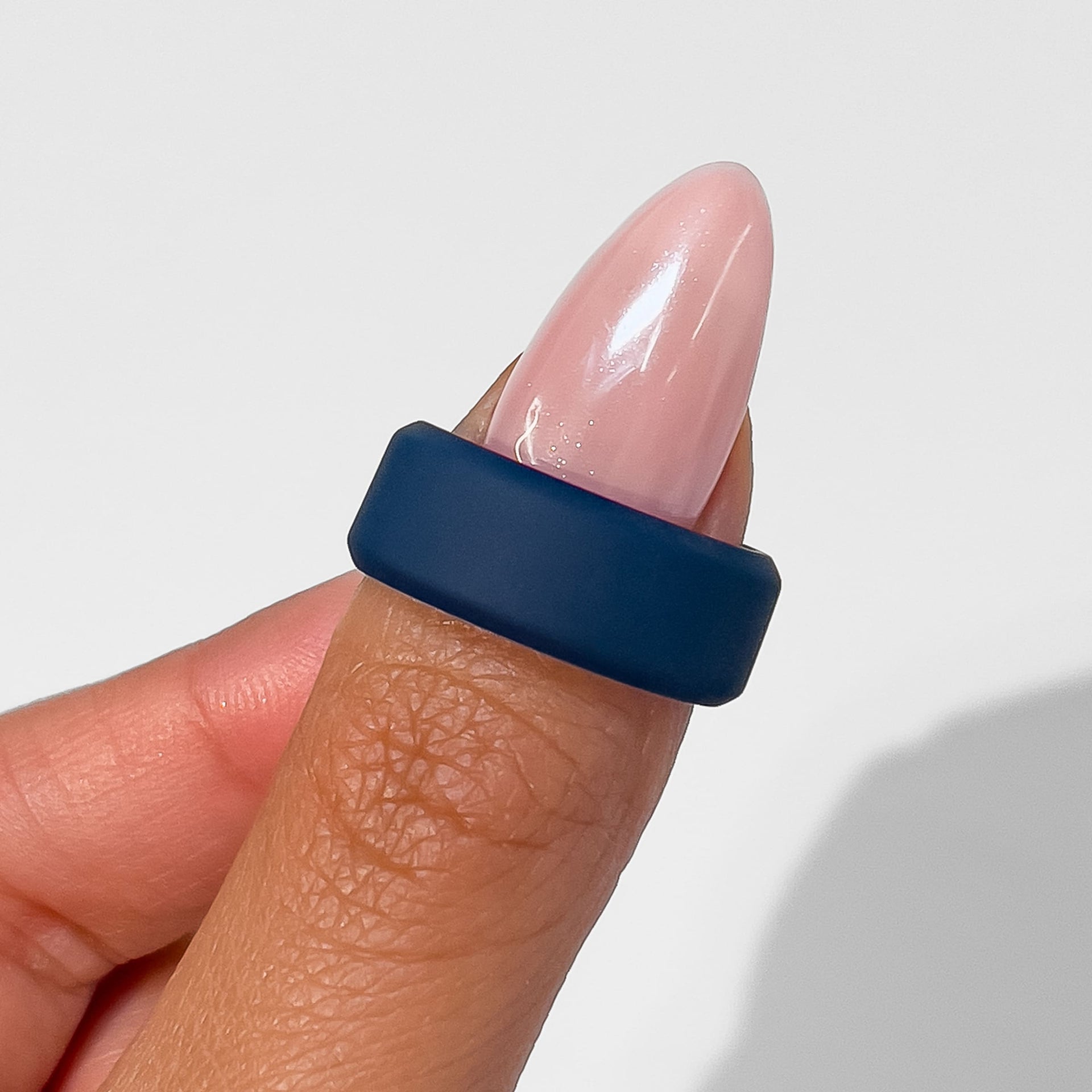 dark blue silicone unisex wedding band held by female model