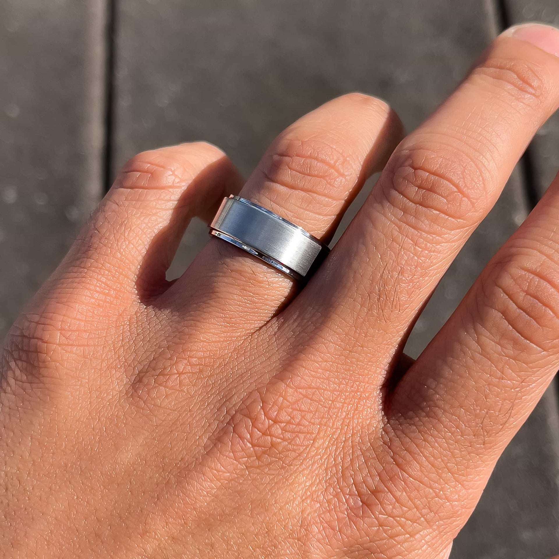 silver excalibur wedding band on man's hand