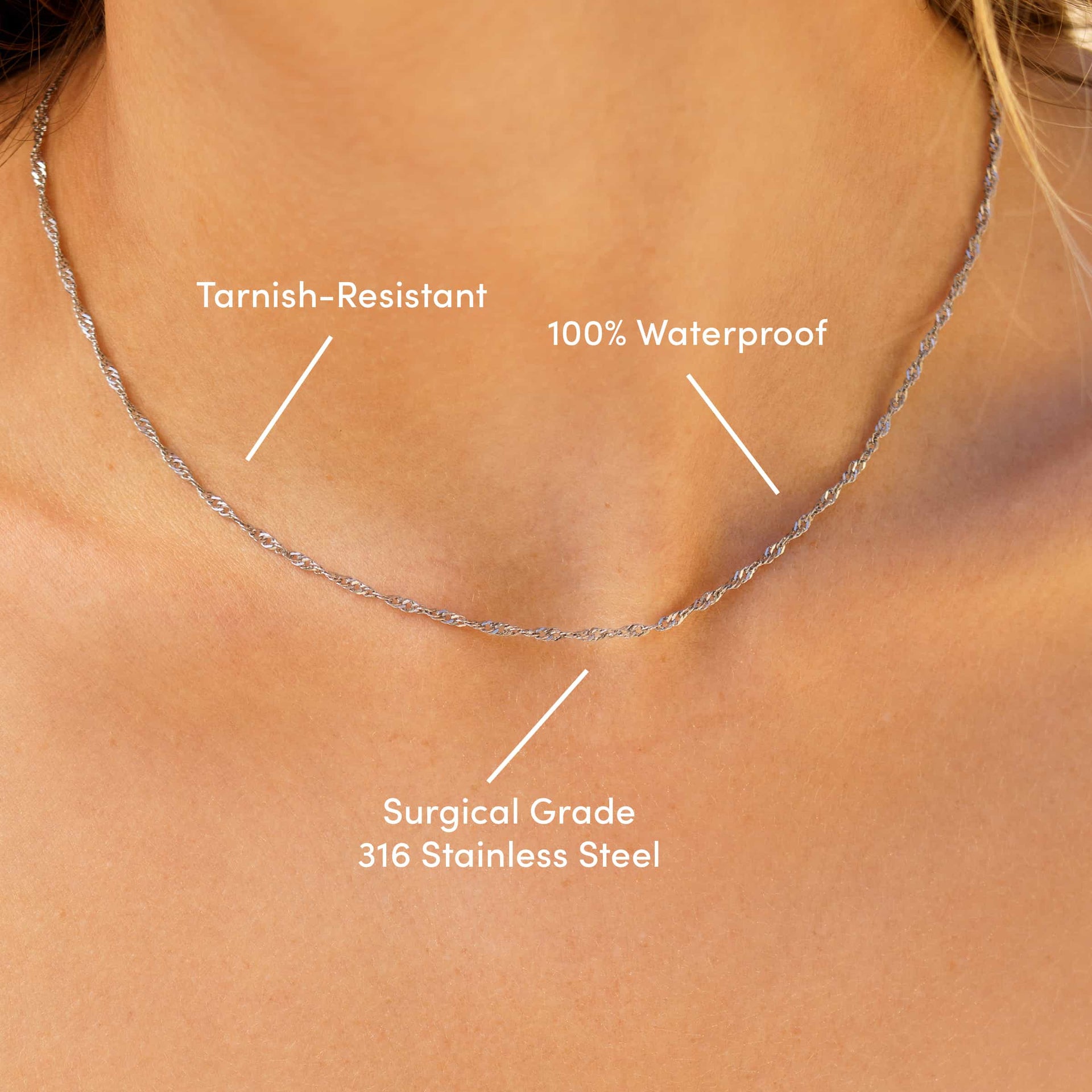 a silver stainless steel singapore chain necklace worn by a model with the text overlayed "100% waterproof, tarnish-resistant, surgical grade 316 stainless steel"