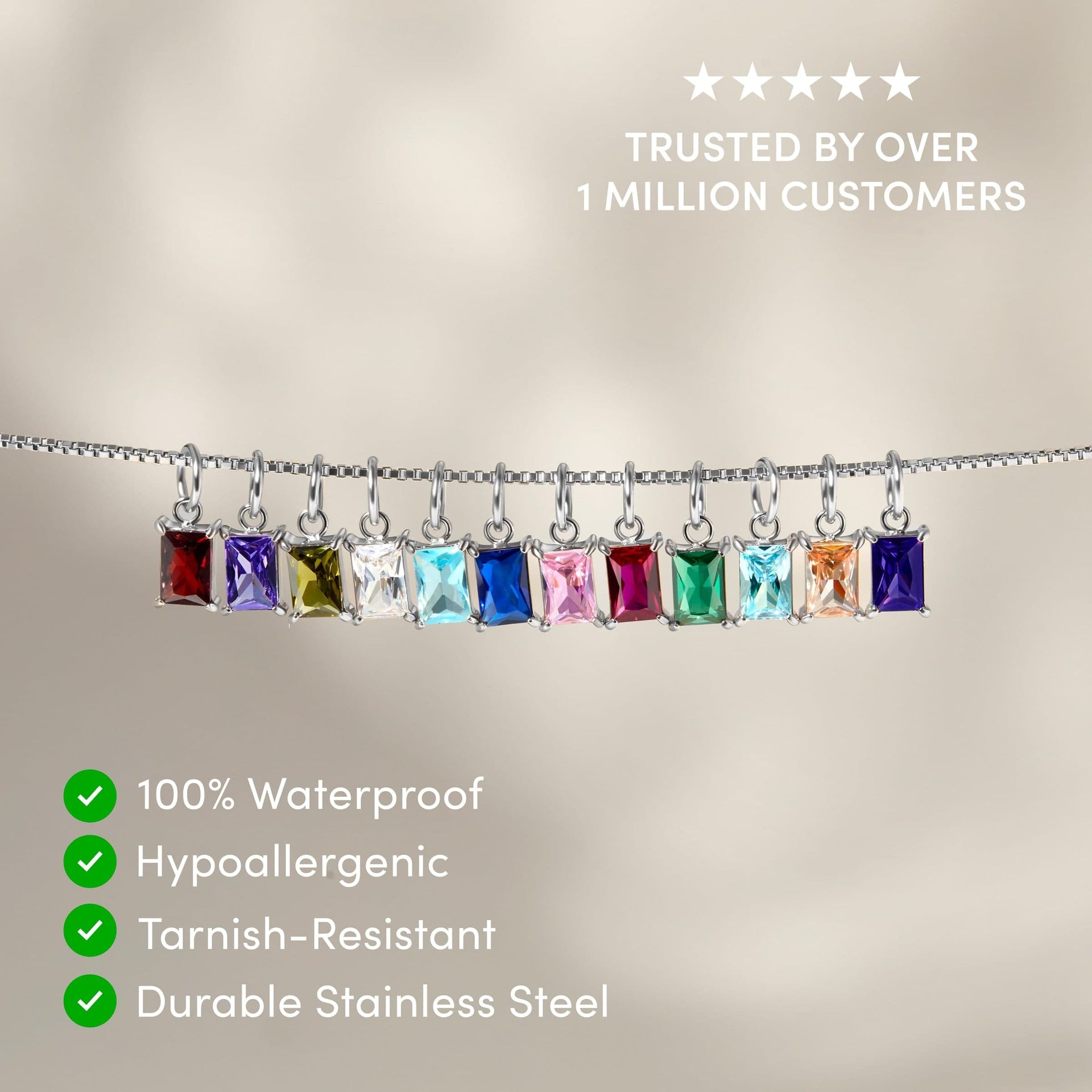 all 12 available radiant cut birthstone charms shown dangling on a silver box chain with the text overlayed "trusted by over 1 million customers, 100% waterproof, hypoallergenic, tarnish-resistant, durable stainless steel"