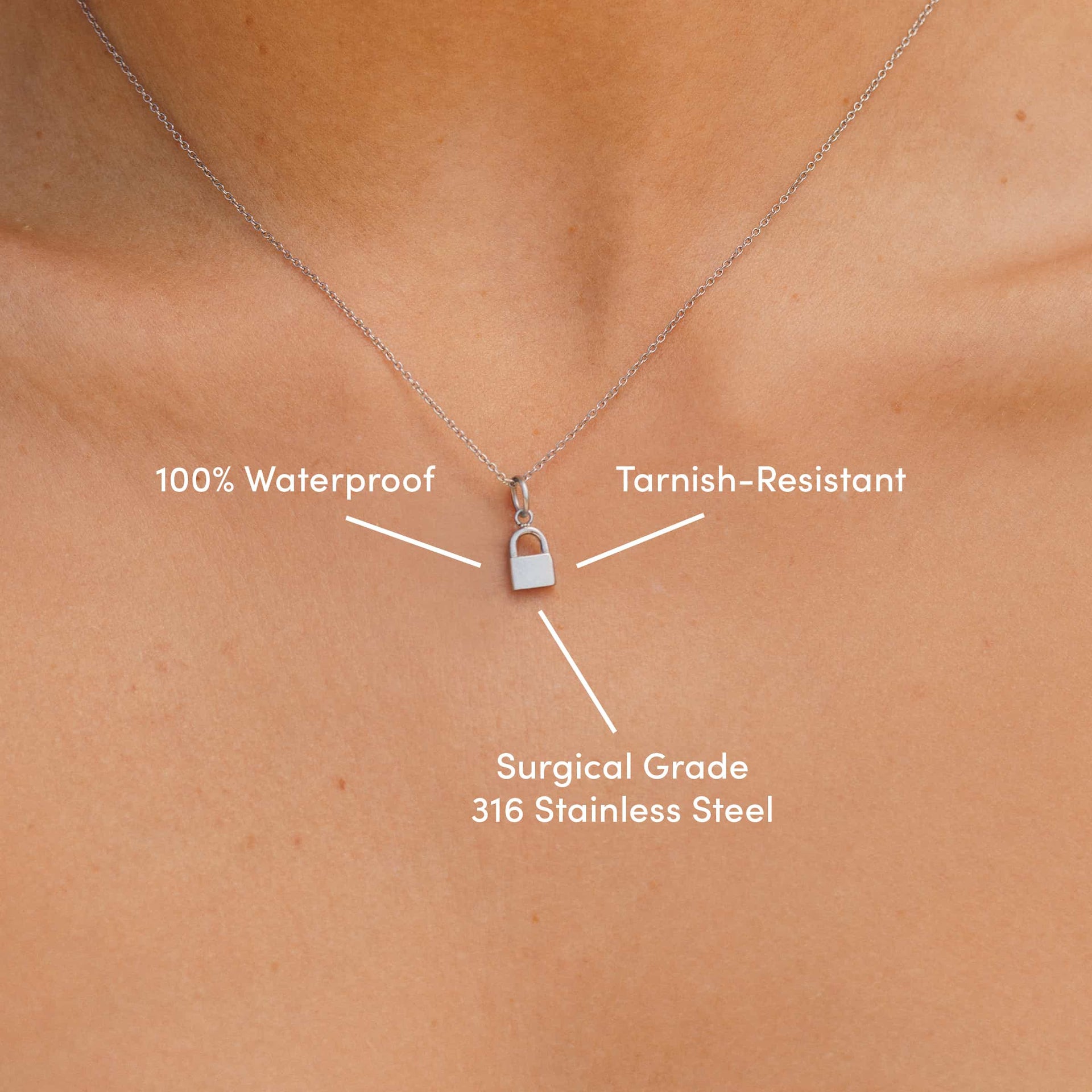 necklace on model's neck with silver stsainless steel lock charm on dainty chain necklace with text overlay that reads "100% waterproof, tarnish-resistant, surgical grade 316 stainless steel"
