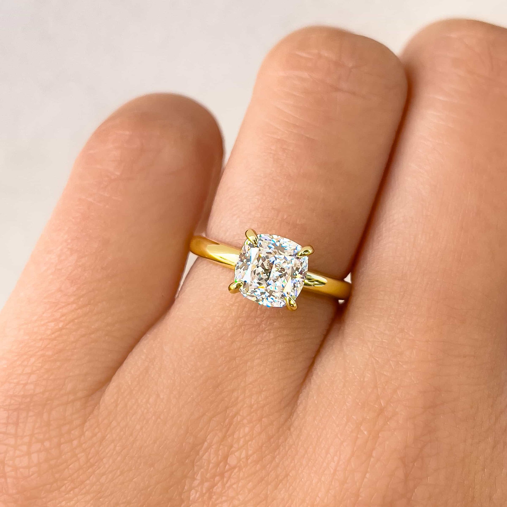 close up shot of gold 1.5 carat solitaire engagement ring