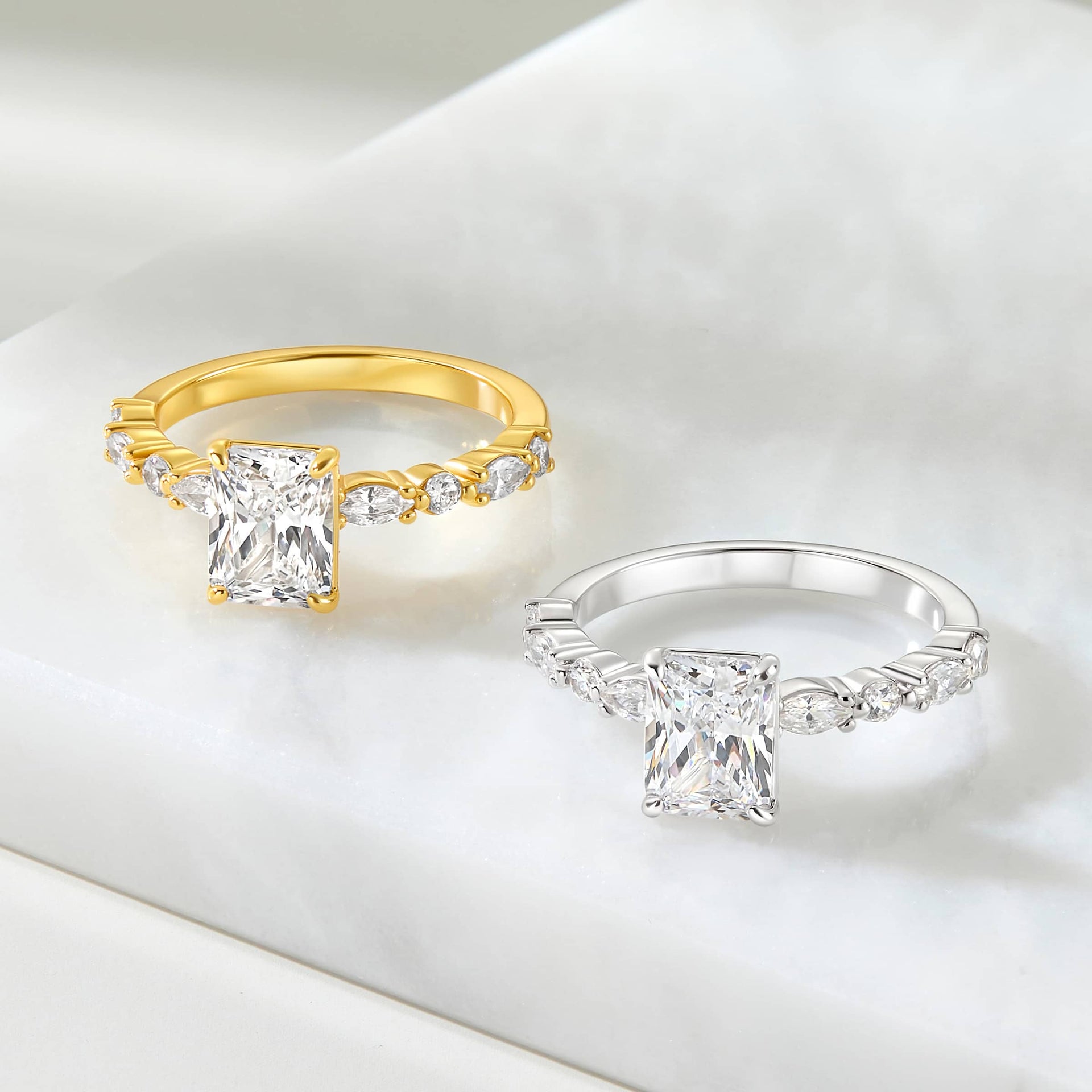 vintage style 2 carat radiant cut half eternity engagement ring shown in gold and silver on an off-white background