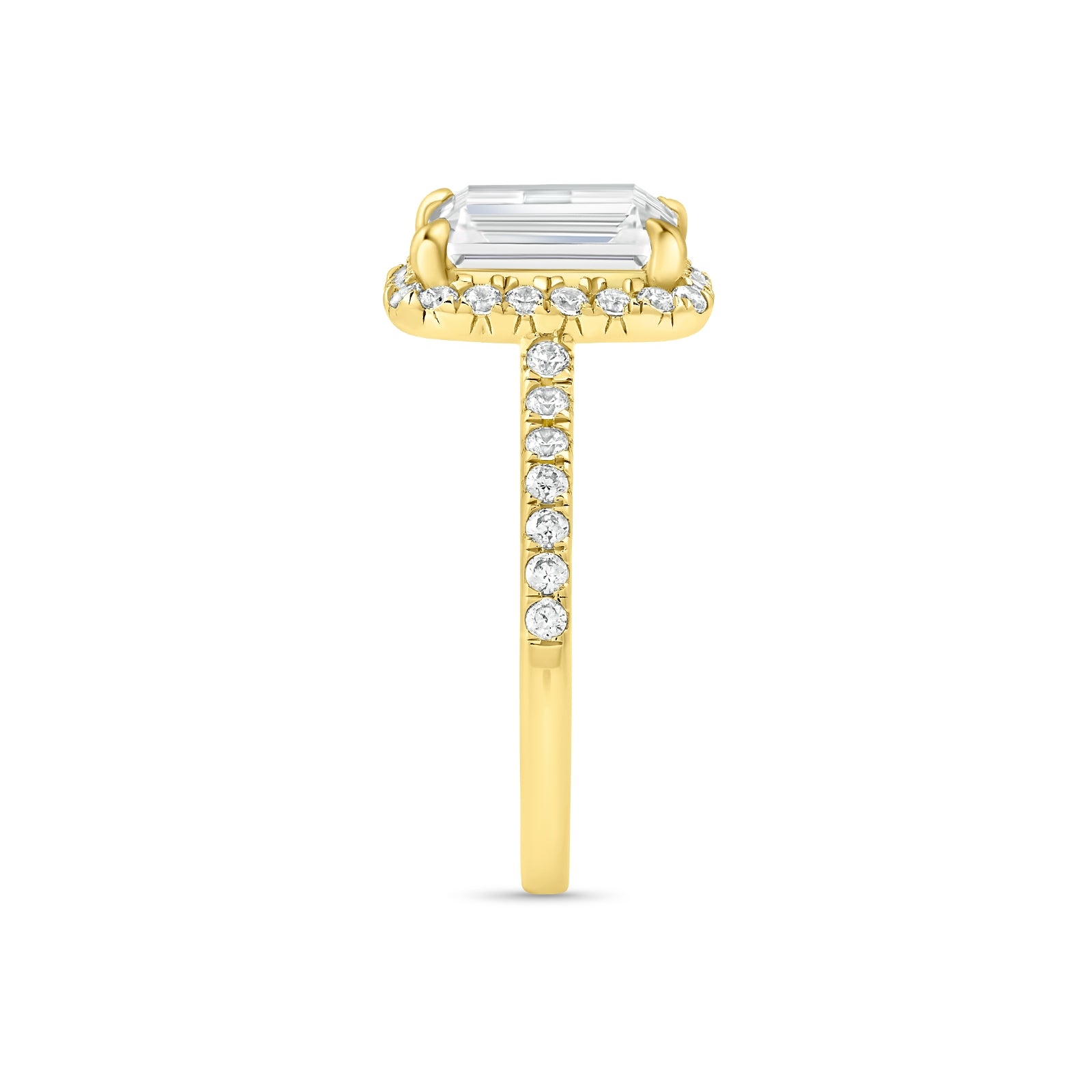 Side profile of gold emerald cut engagement ring with half eternity band detailing