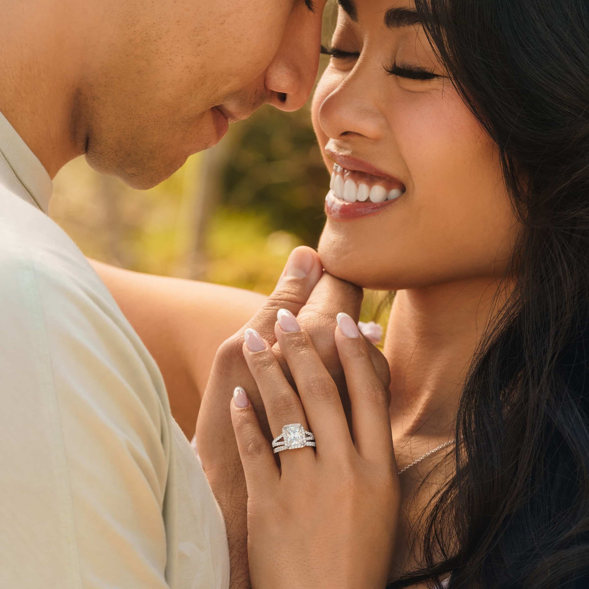 silver evelyn wedding ring set on ladies hand with couple