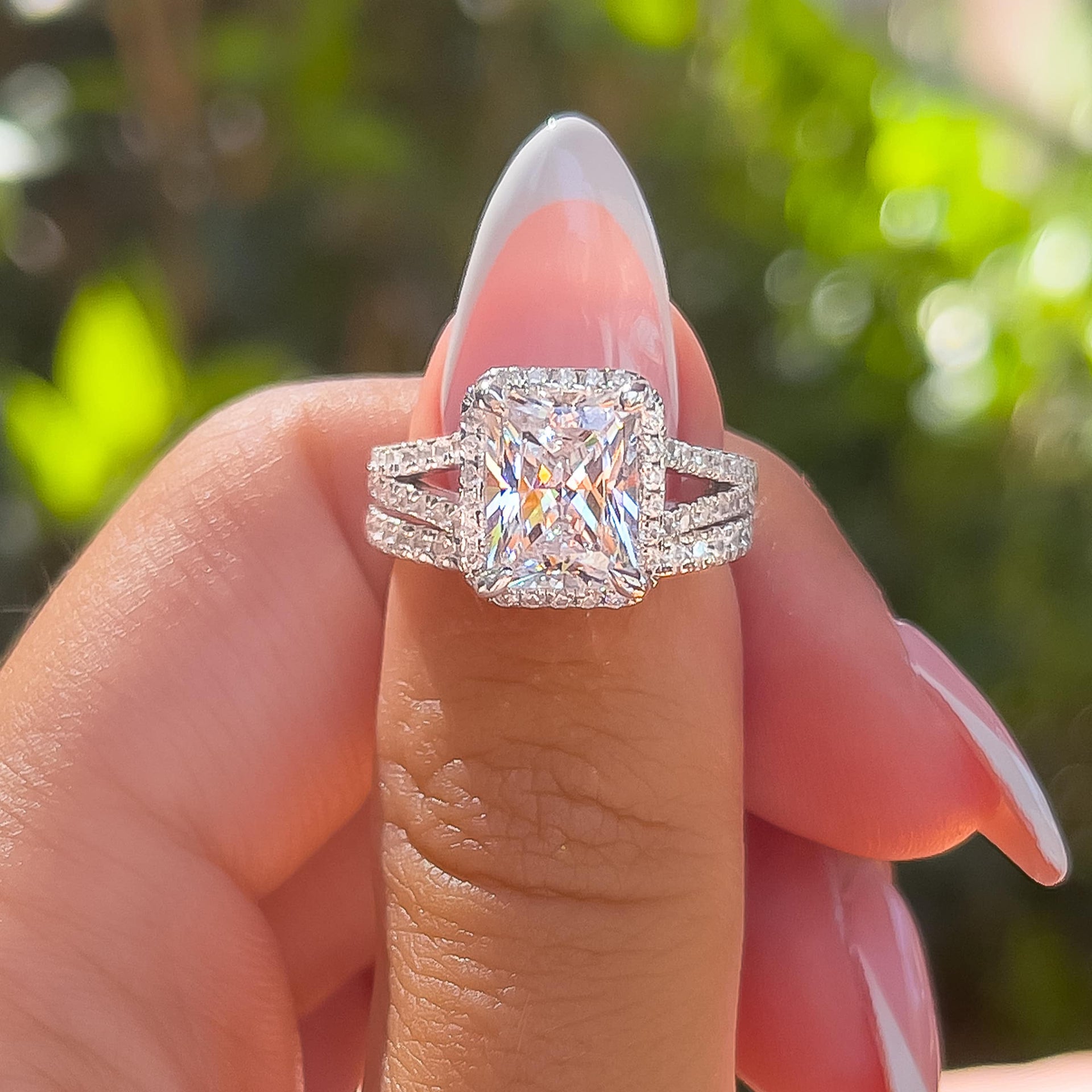 3.5 carat radiant cut with a shimmering halo surrounding the center stone on ladies thumb