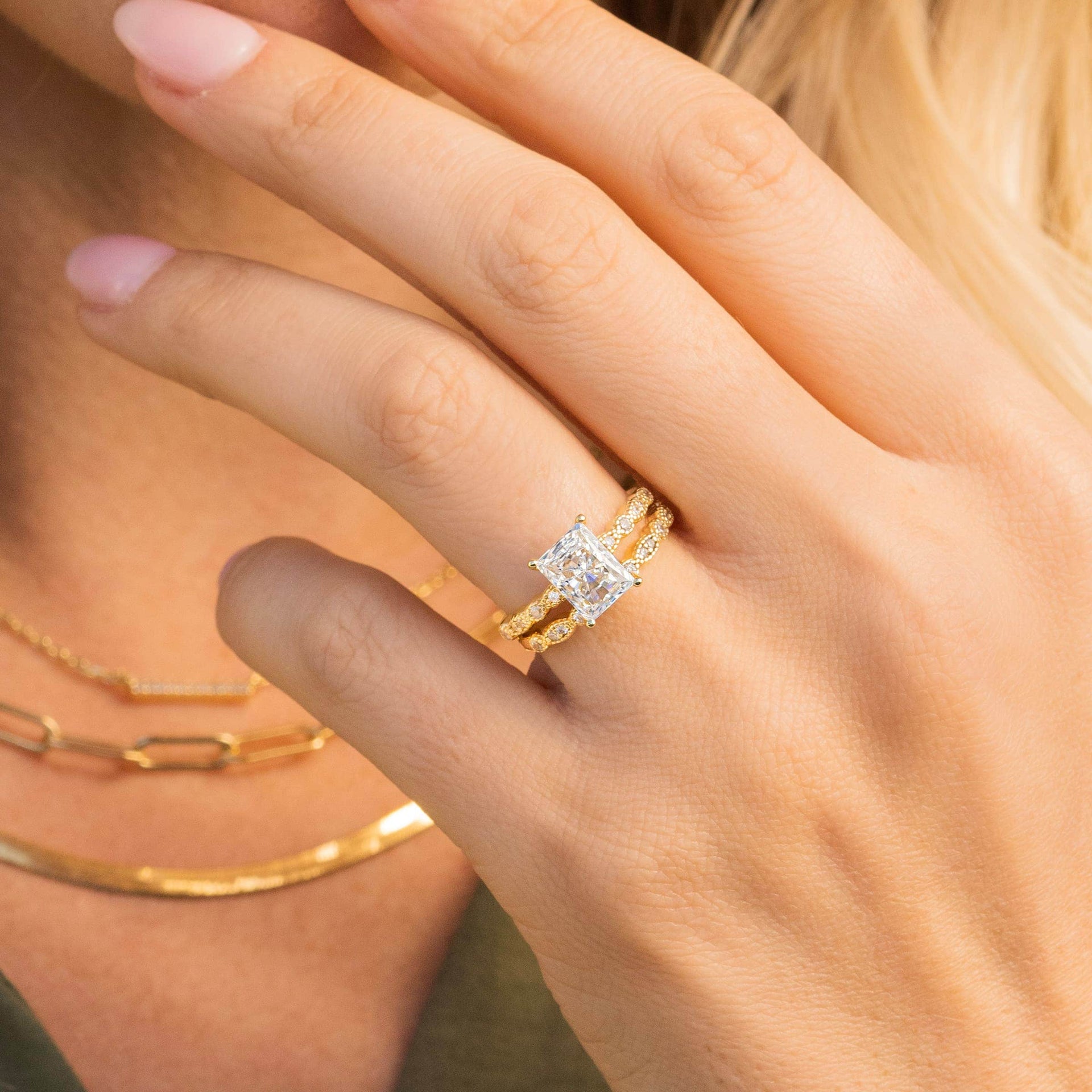 woman wearing gold vintage wedding ring with vintage wedding band