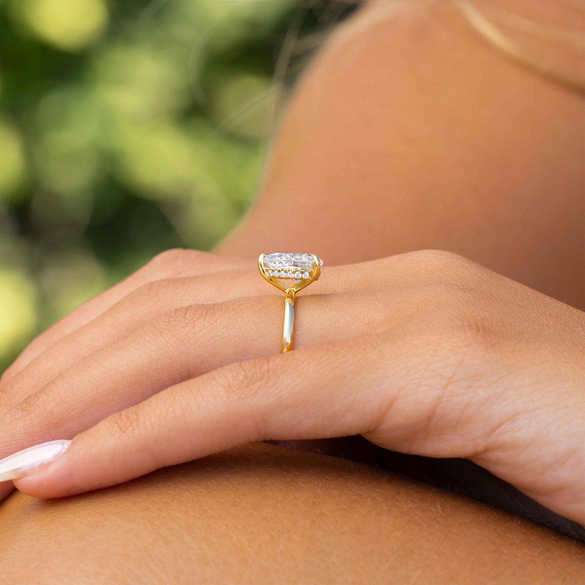 Yellow gold pear cut solitaire ring with hidden halo.