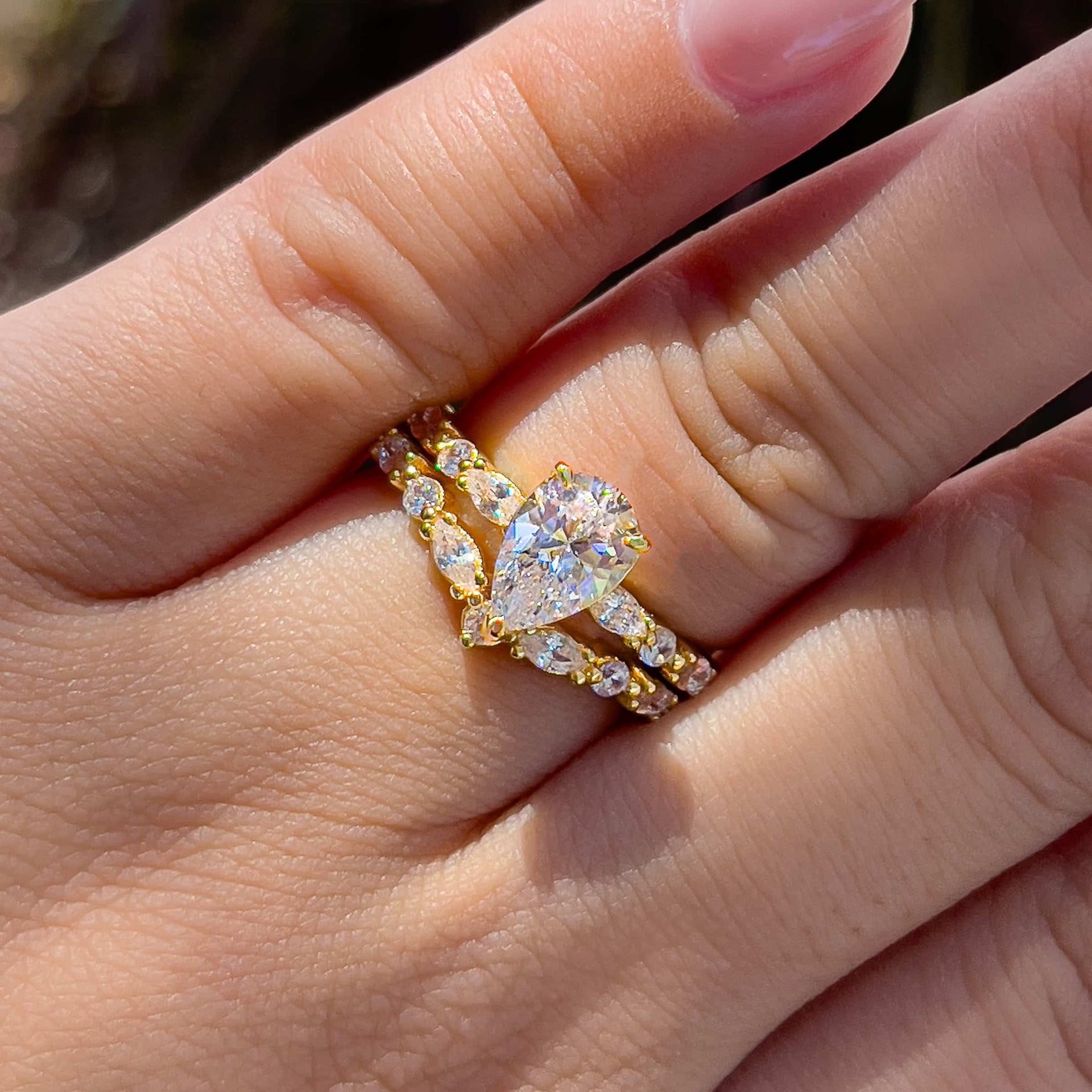 vintage gold pear cut wedding ring set on female model