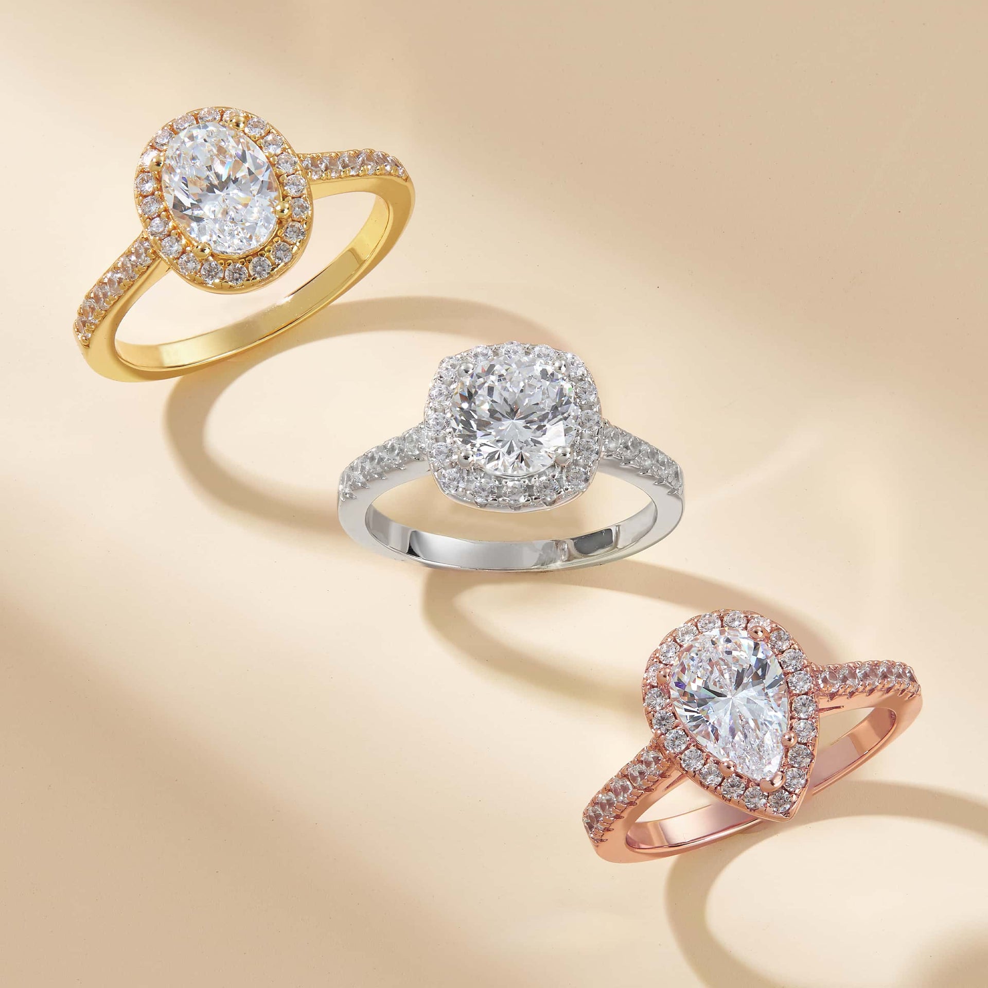 gold halo engagement ring with silver and rose gold rings