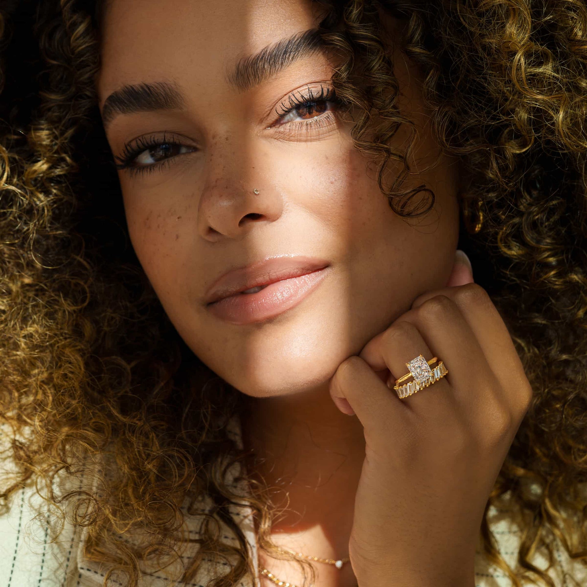 gorgeous model wearing gold radiant cut engagement ring