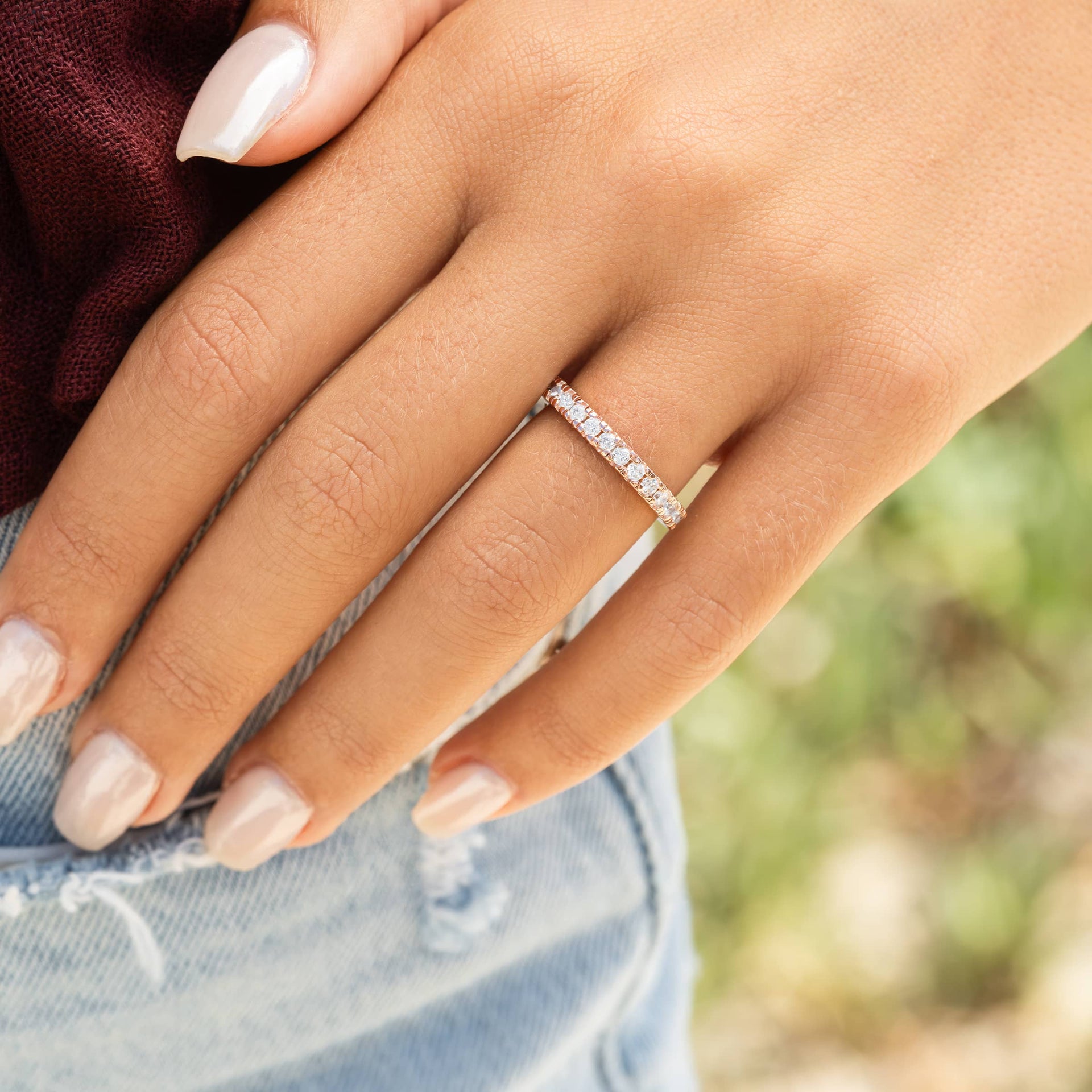 woman wearing rose gold eternity wedding band