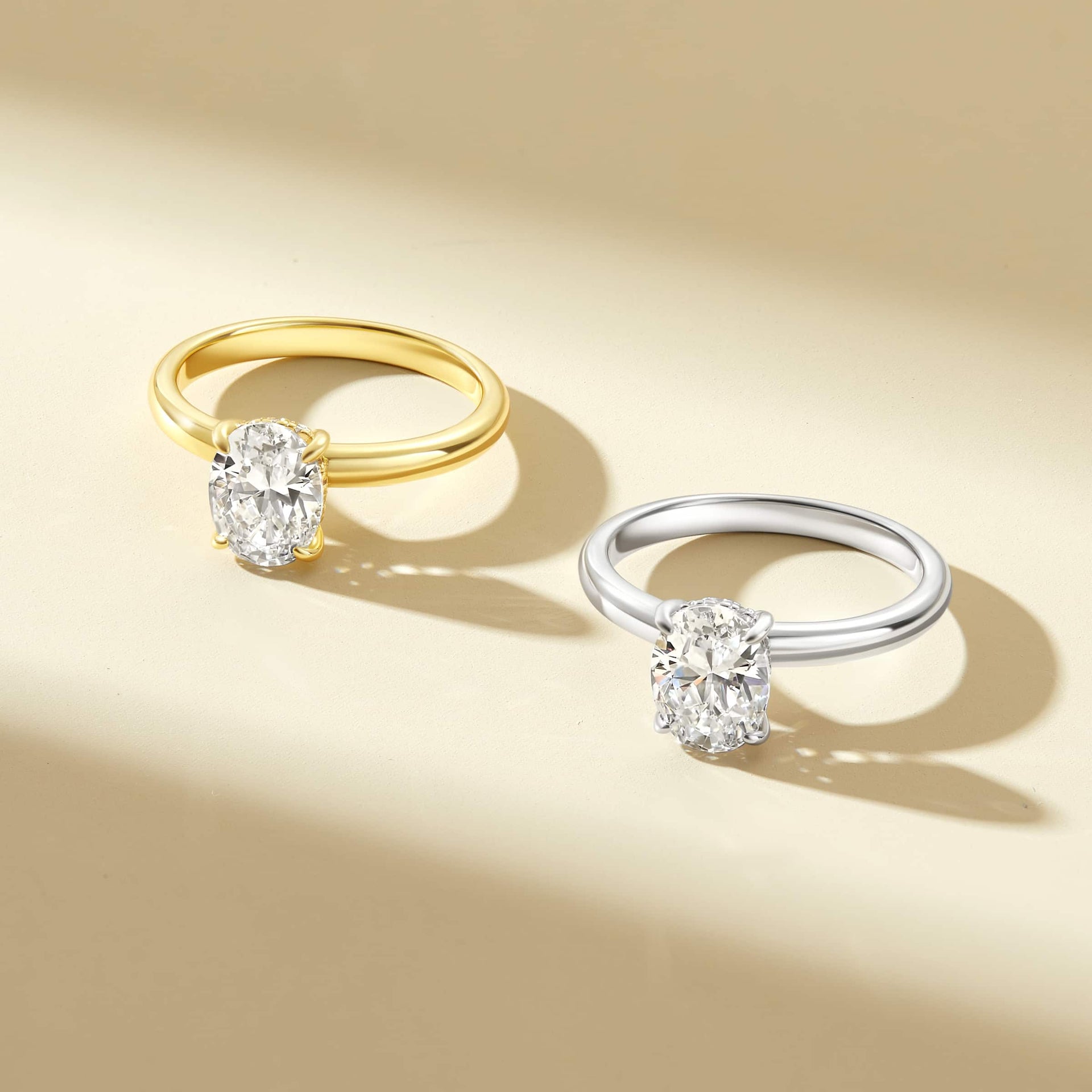 gold and silver petite solitaire glistening engagement rings on a cream background