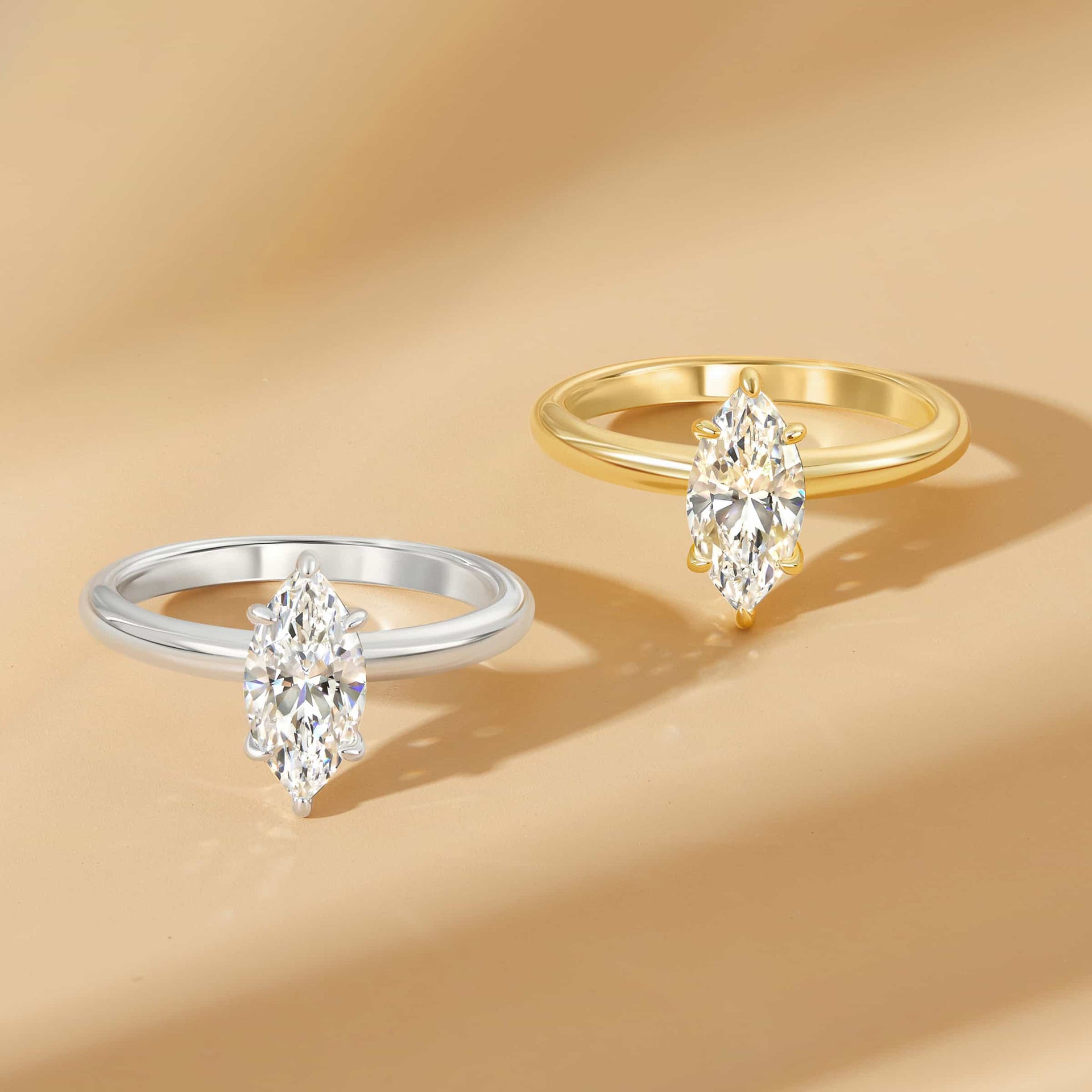 A stunning 1 carat marquise cut solitaire engagement ring shown in both silver and gold