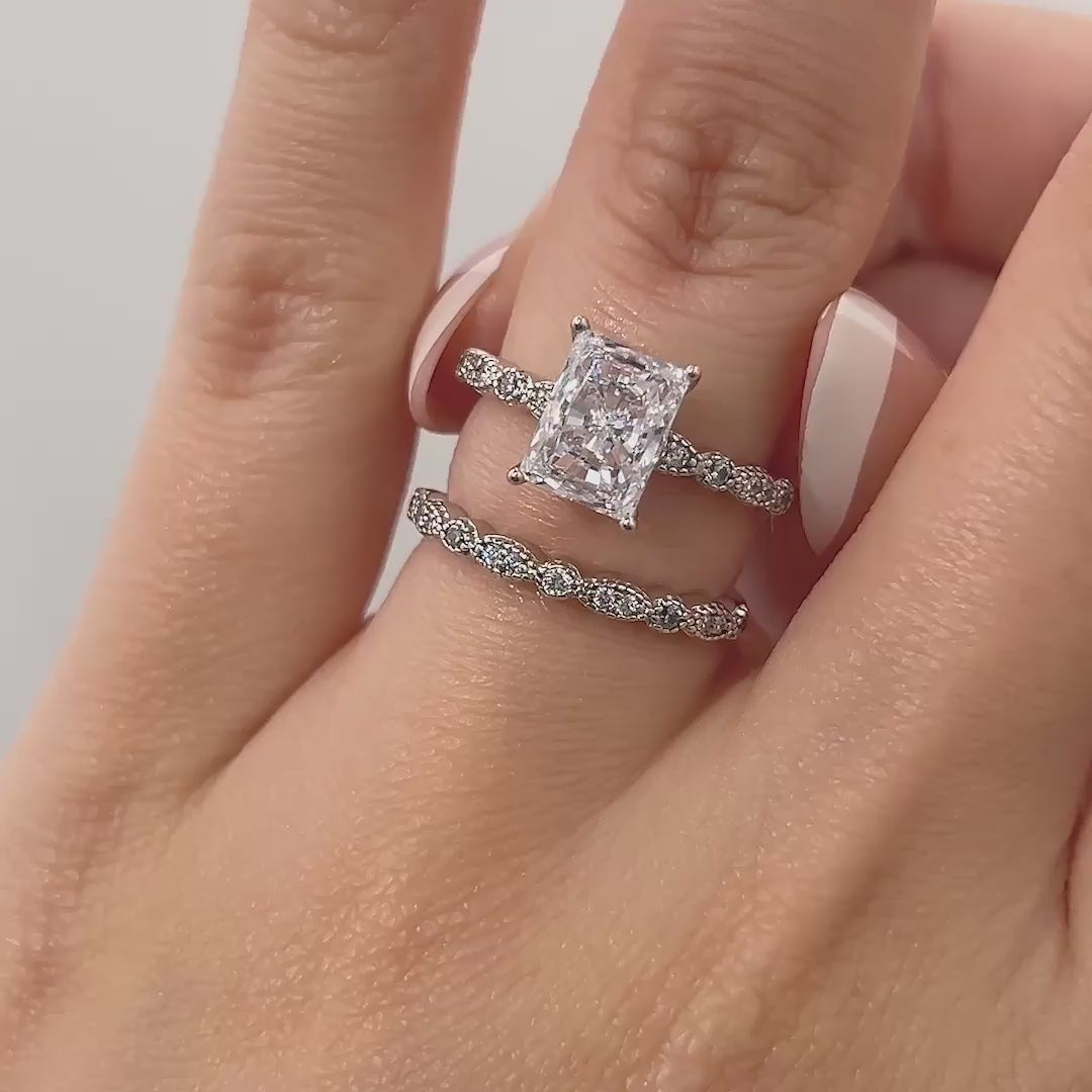 video of silver 1.5 carat radiant cut vintage style wedding ring set on model with french tip nails