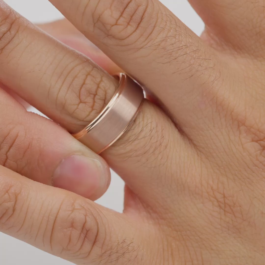 video of a rose gold tungsten carbide wedding band worn by model