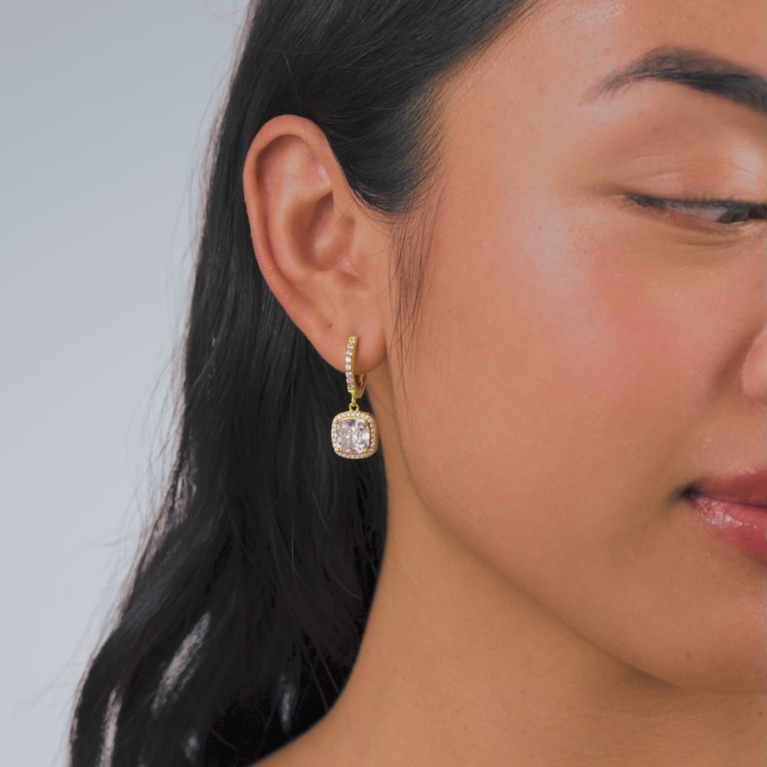 video of gold bold cushion cut halo pendant dangling hoop earrings on a model