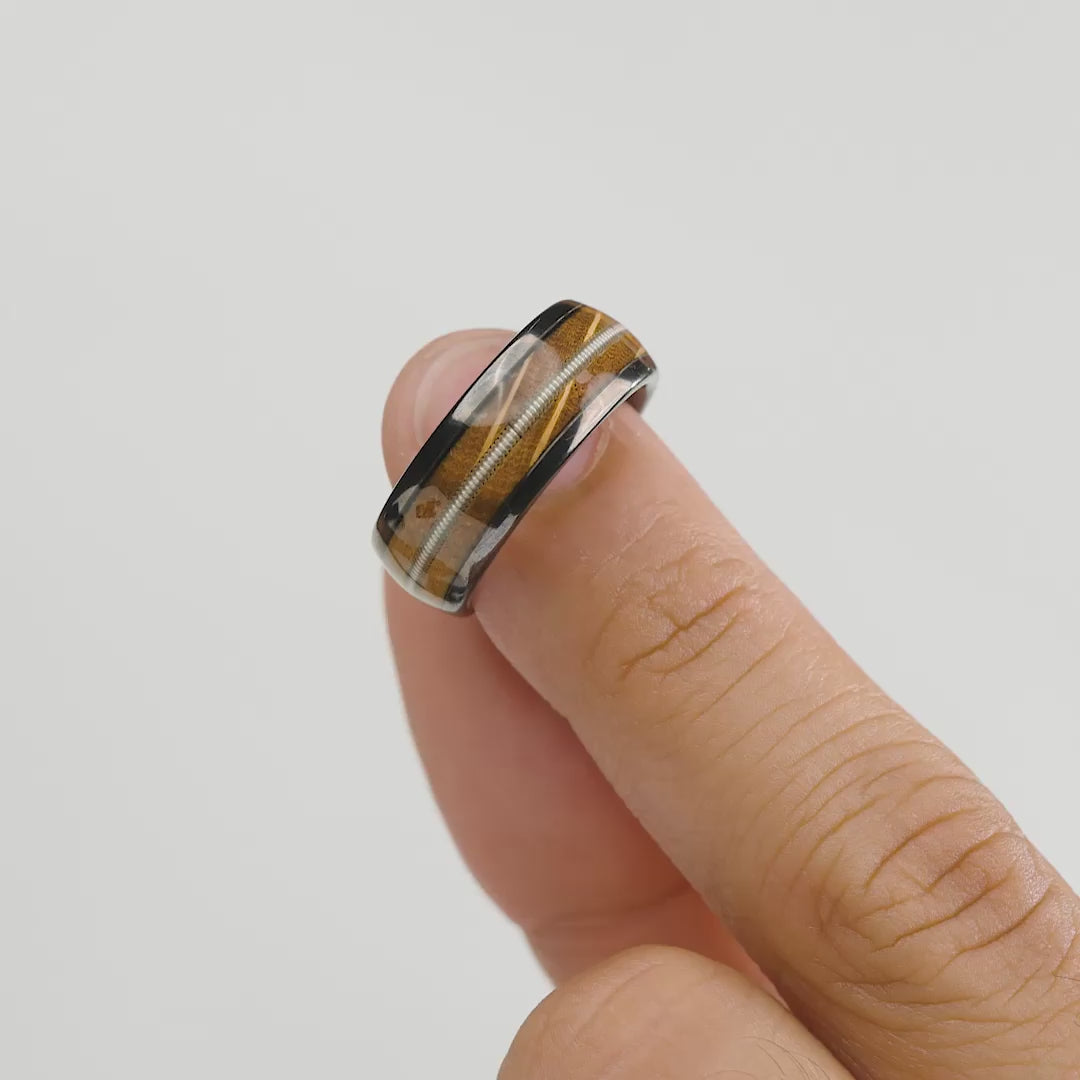 Video of  tungsten carbide men's ring with wood and guitar string inlay