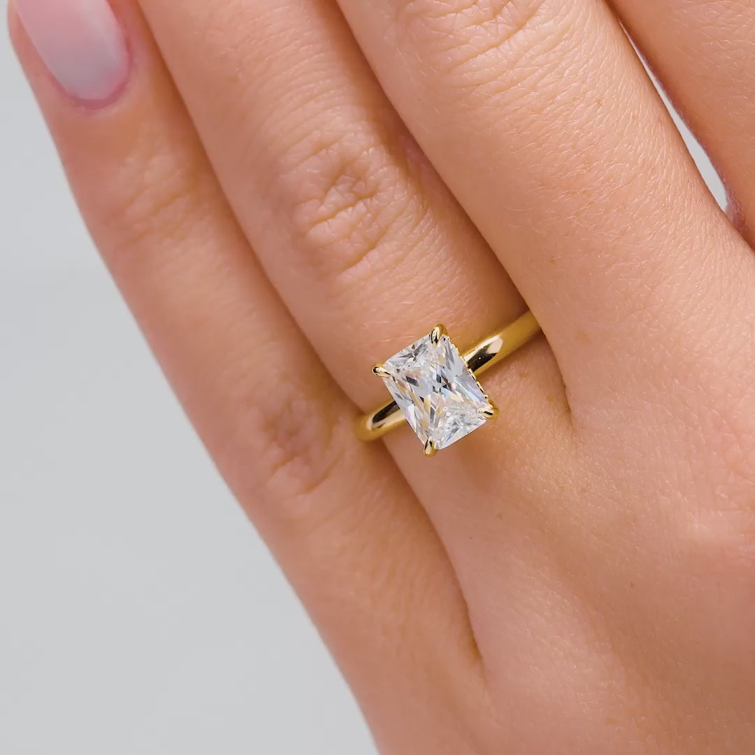 video of gold 1.5 carat radiant cut solitaire engagement ring with hidden halo on female model