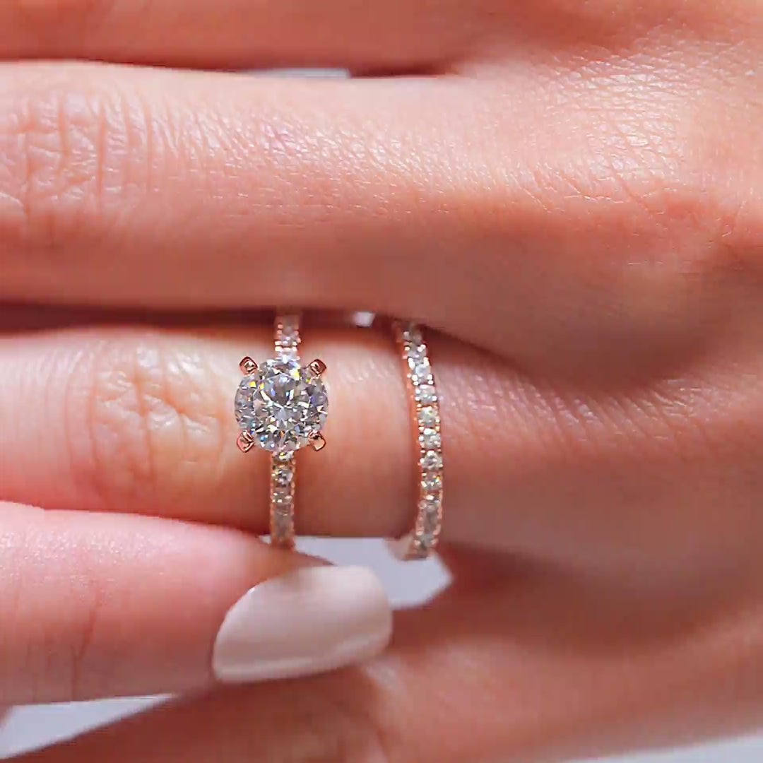 video of classic rose gold round cut, half eternity wedding ring set on a model with white nails