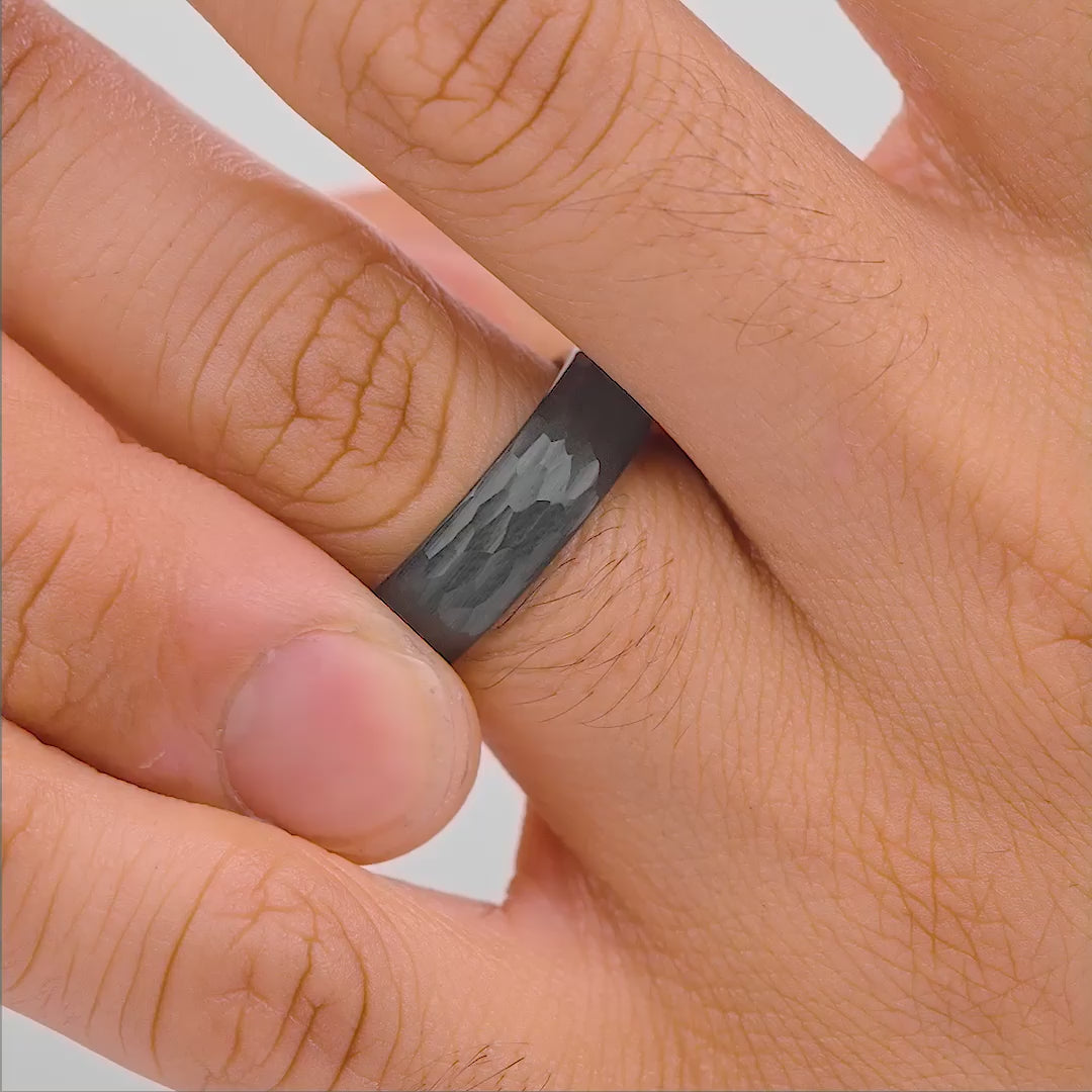 mens hammer slate affordable wedding ring on hand in studio setting