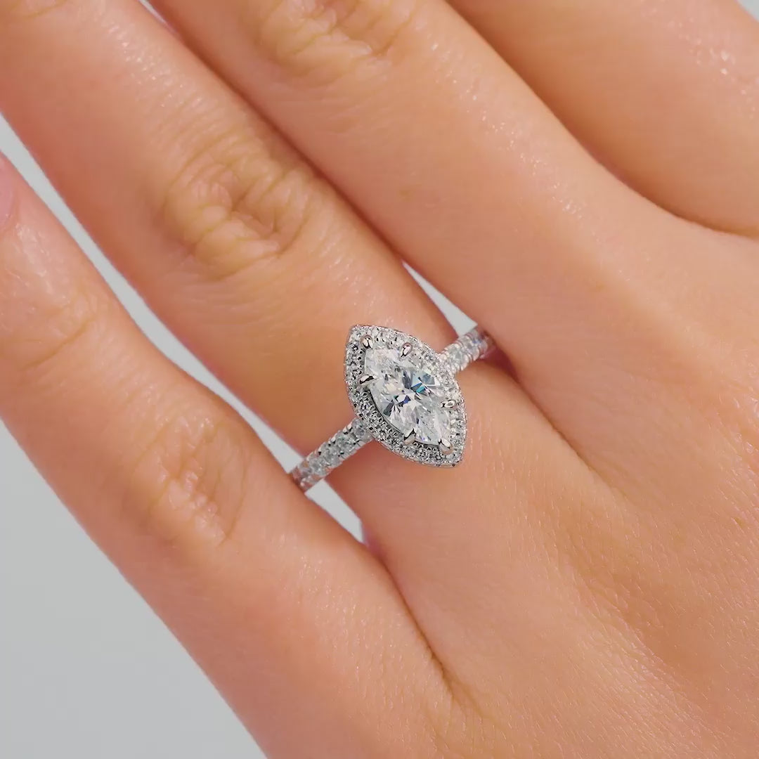 video of 1 carat halo marquise engagement ring with half eternity band detail on female model