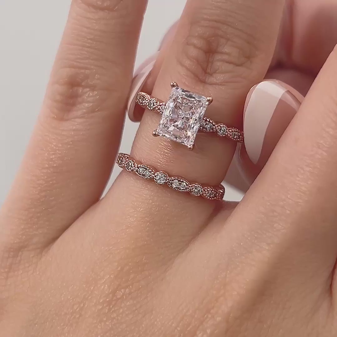 video of rose gold 1.5 carat radiant cut vintage style wedding ring set on model with french tip nails